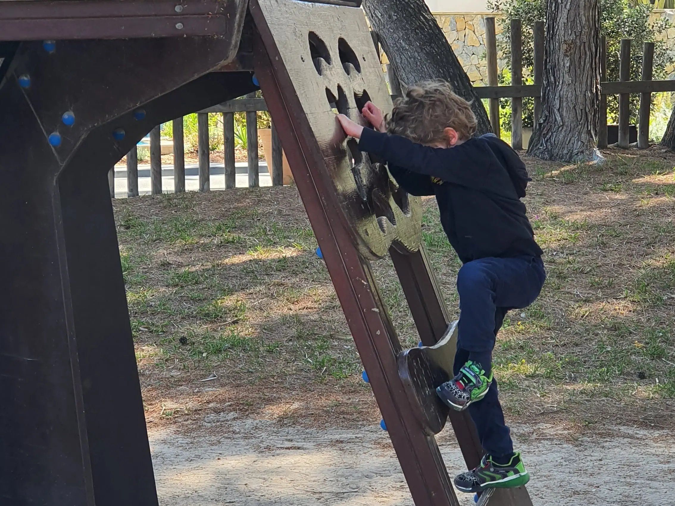 A child on a playground at a resort.
