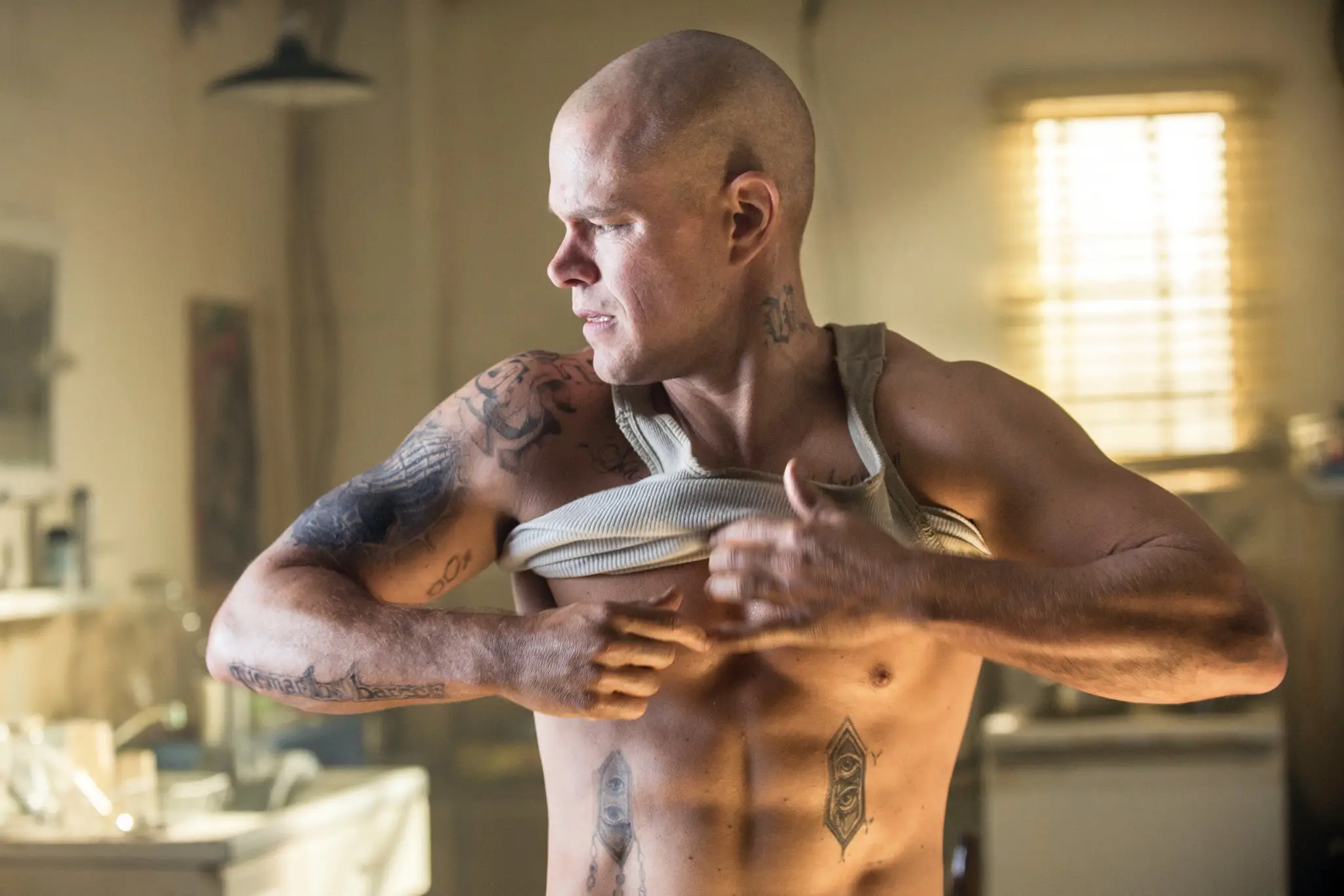 Matt Damon putting on a shirt