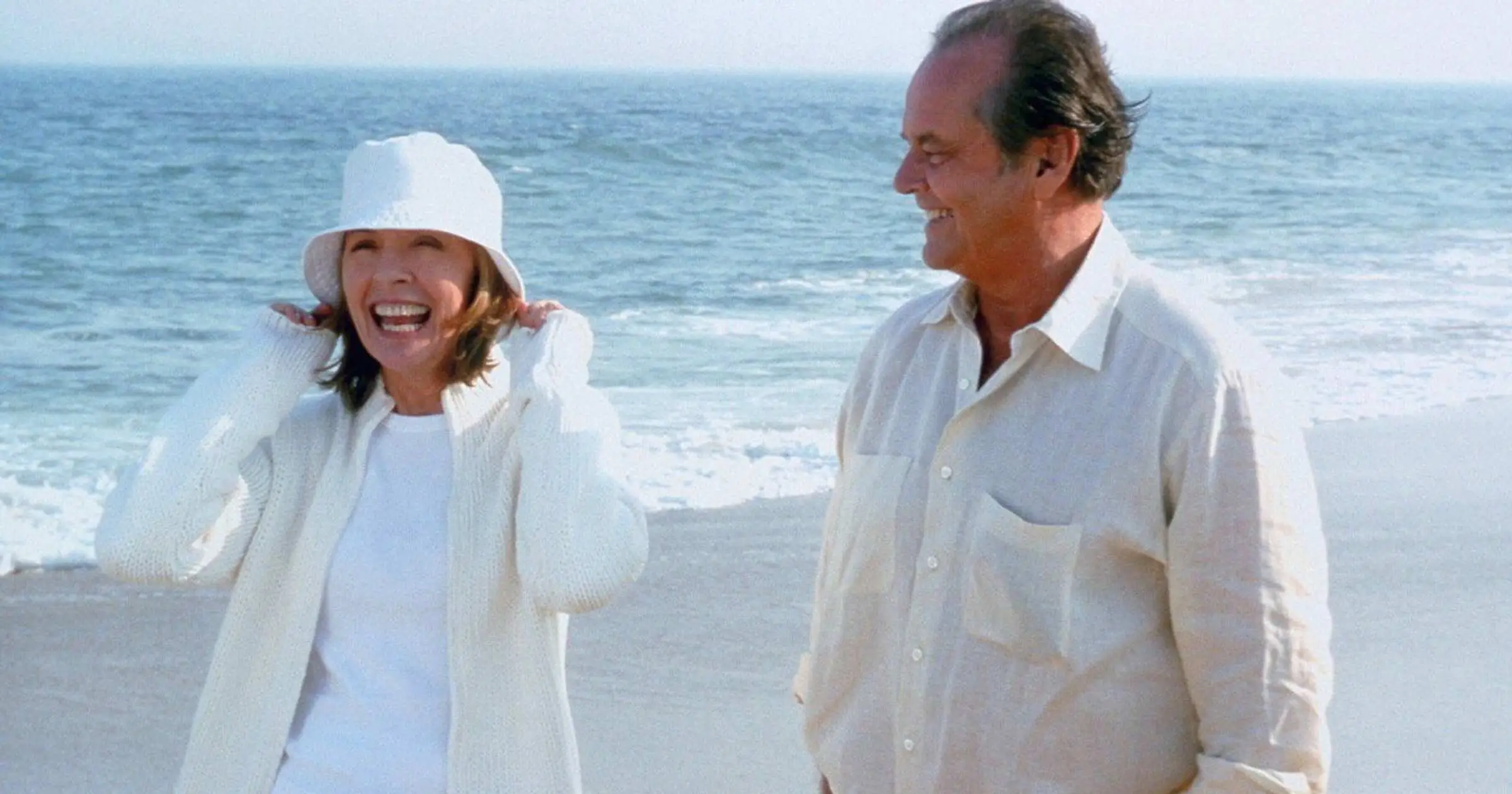 Diane Keaton laughing standing next to Jack Nicholson on the beach