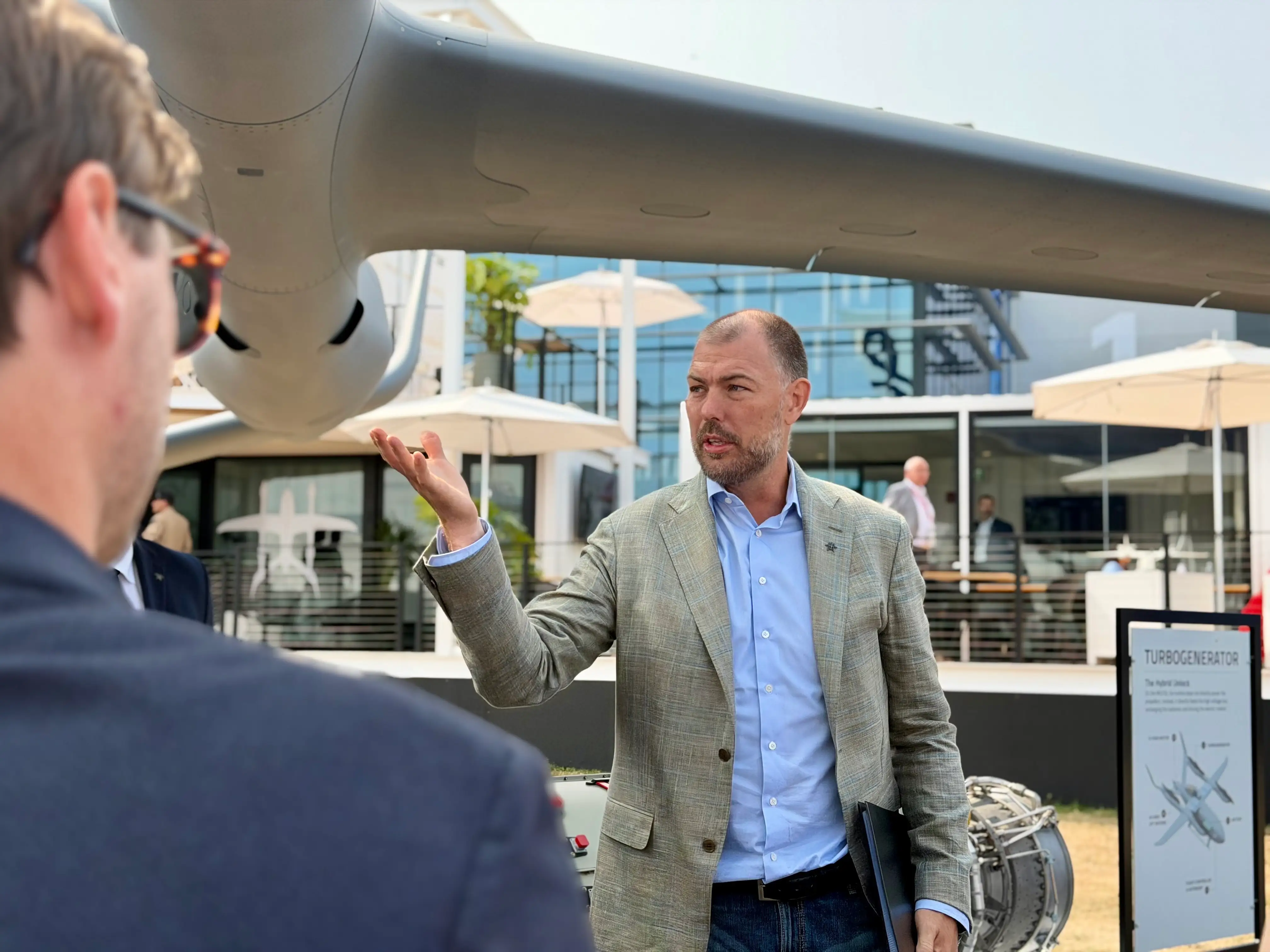 Beta Technologies CEO Kyle Clark talks in front of a ALIA MV250 aircraft at the 2026 Farnborough Airshow