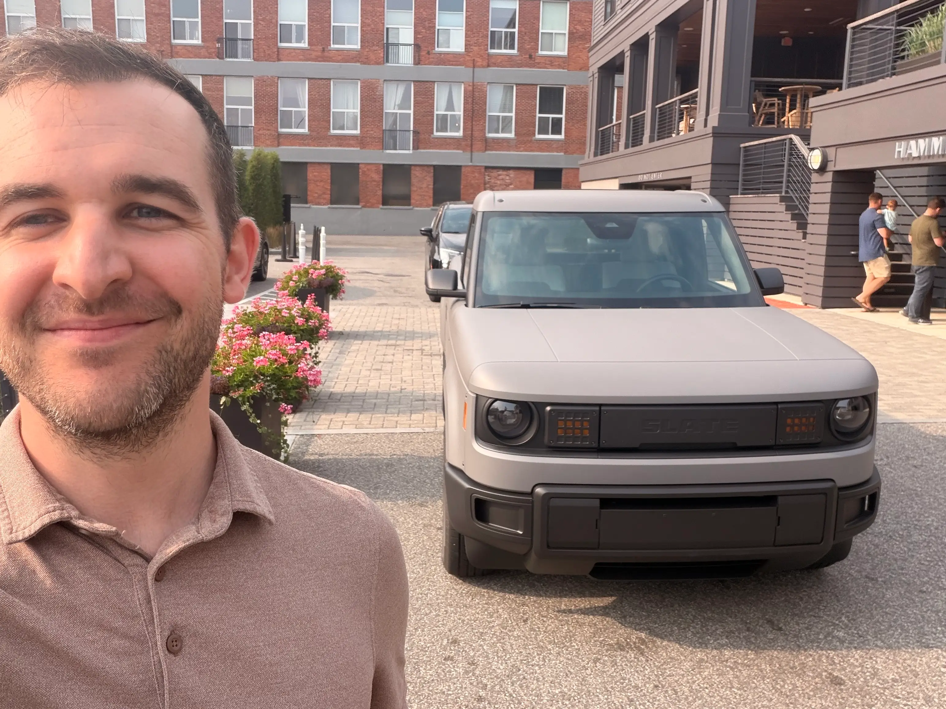 Ben Shimkus, a reporter at Business Insider, stands in front of the base model Slate Truck.