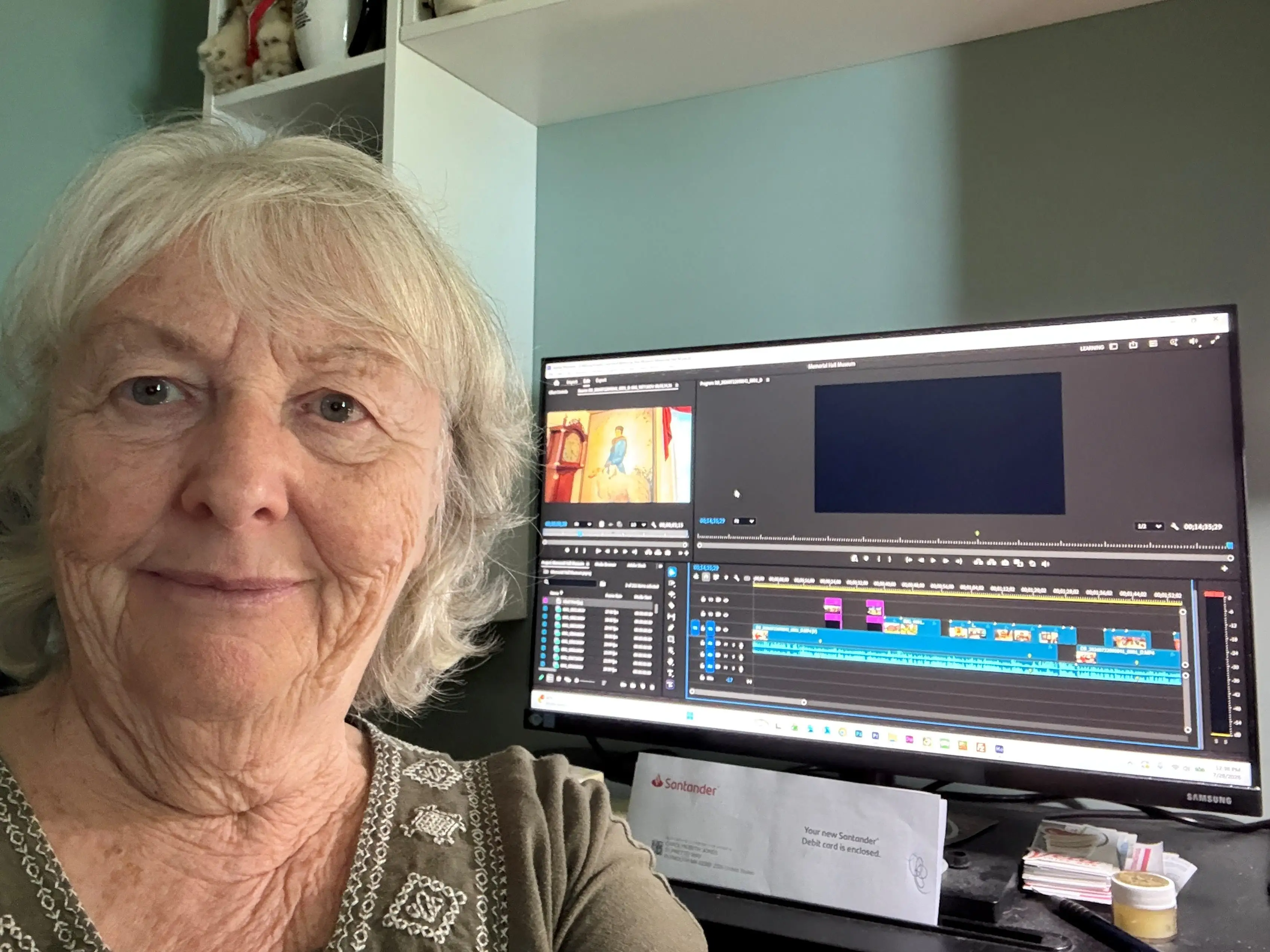 Beth Sobiloff taking a selfie in front of a computer screen that has a video editing software open