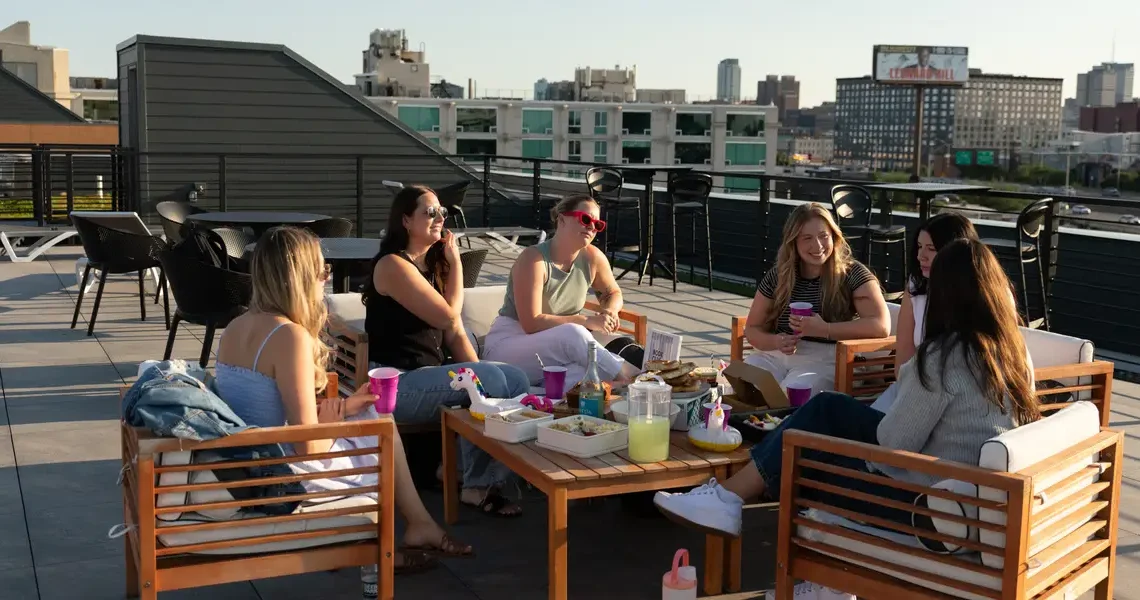 Third places are out, as prices rise. Hosting dinners, craft nights, and book clubs are in.