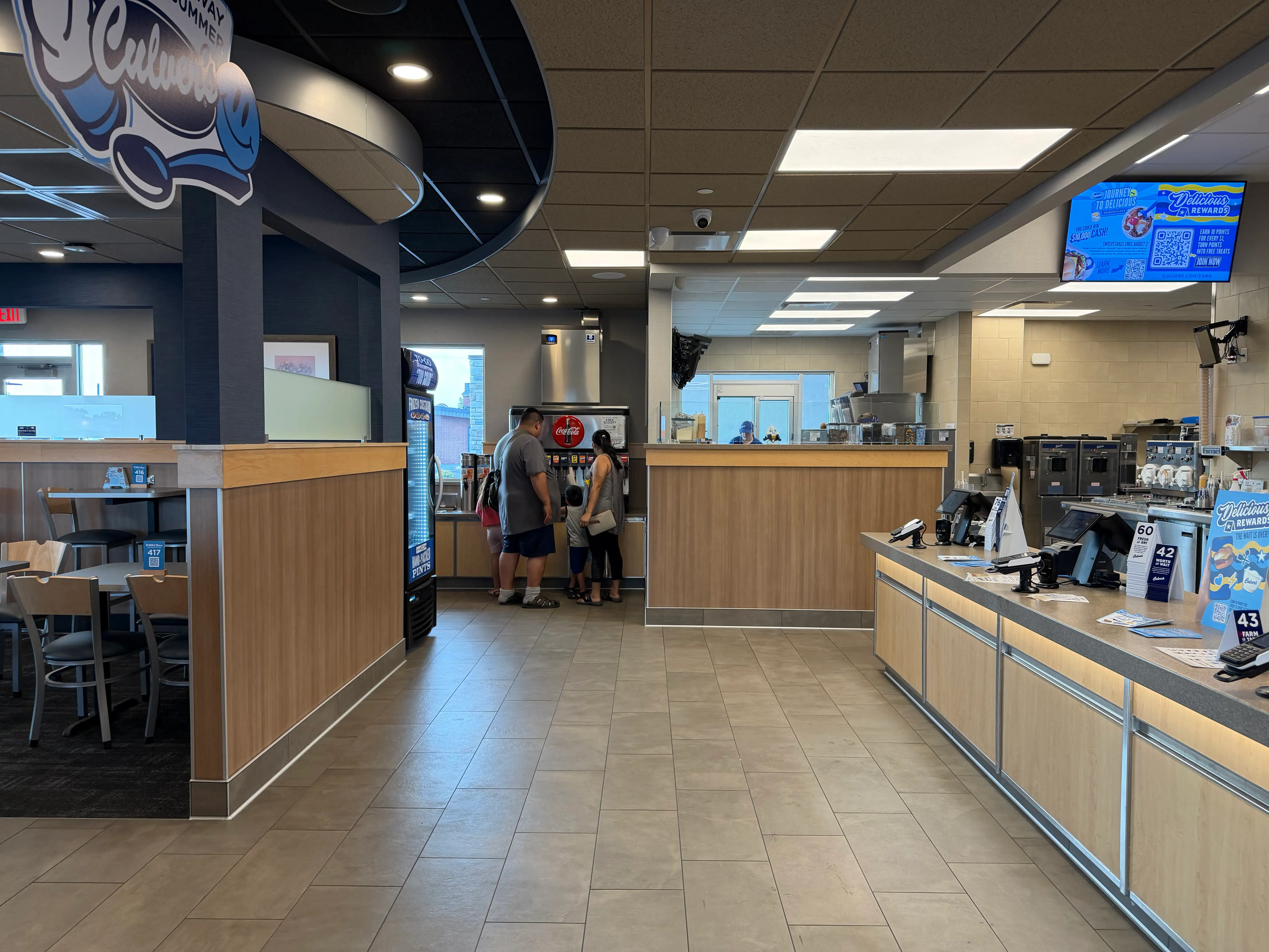 Interior of Culvr's with faux wood dividers, carpet under seating area, beige tiles