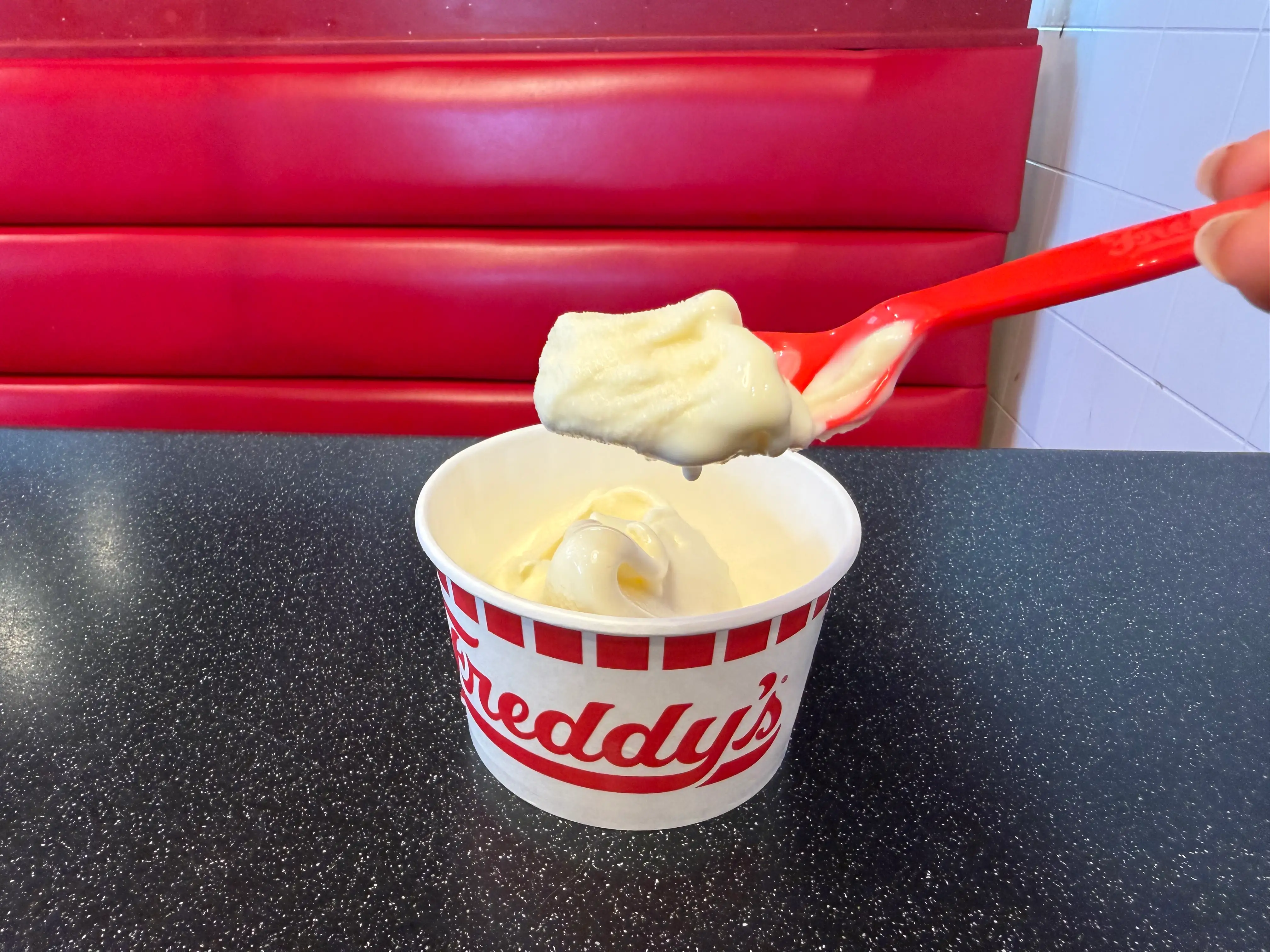 Spoon scooping up Freddy's vanilla custard