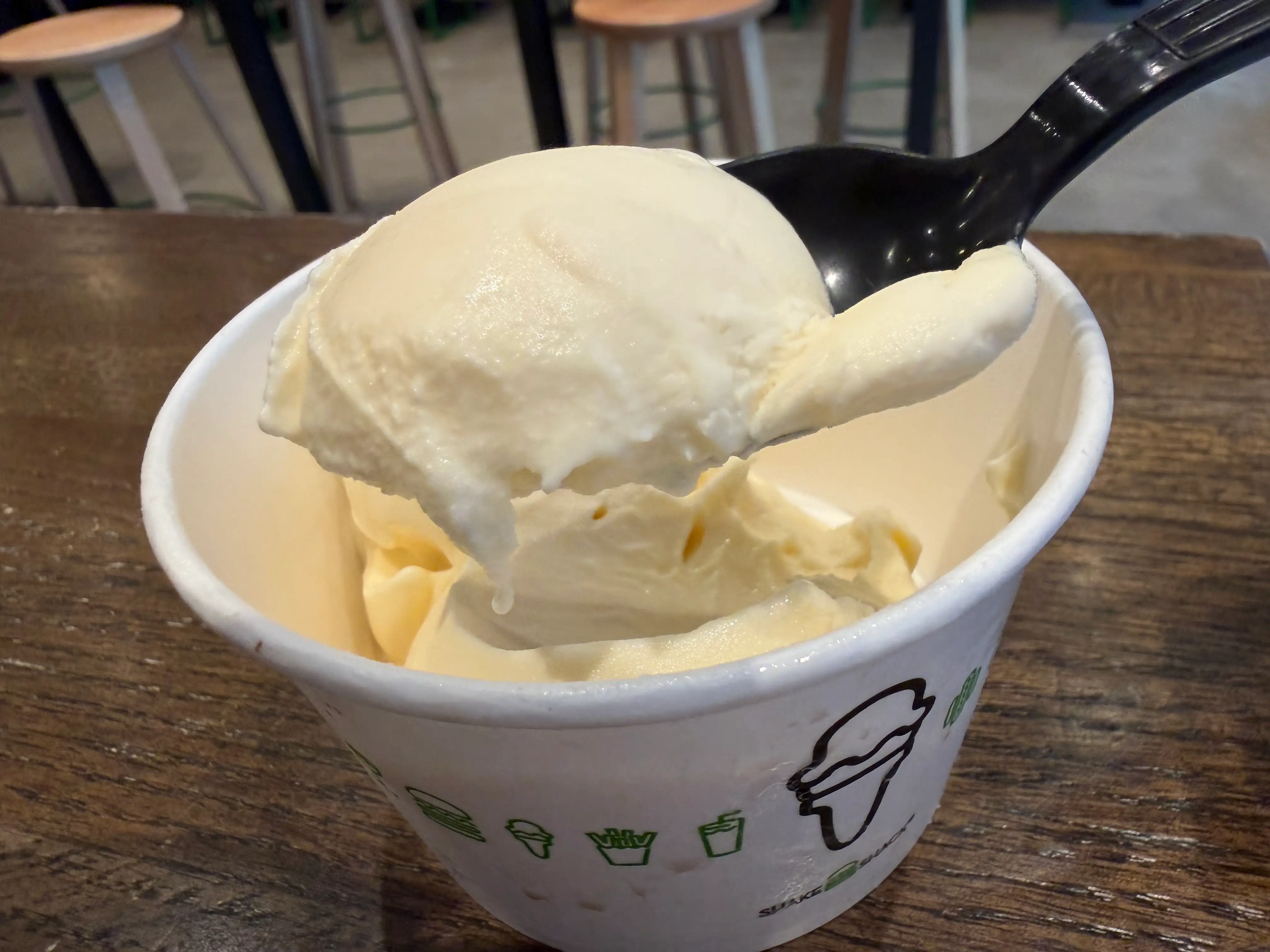 Spoon scooping up vanilla custard of Shake Shack custard