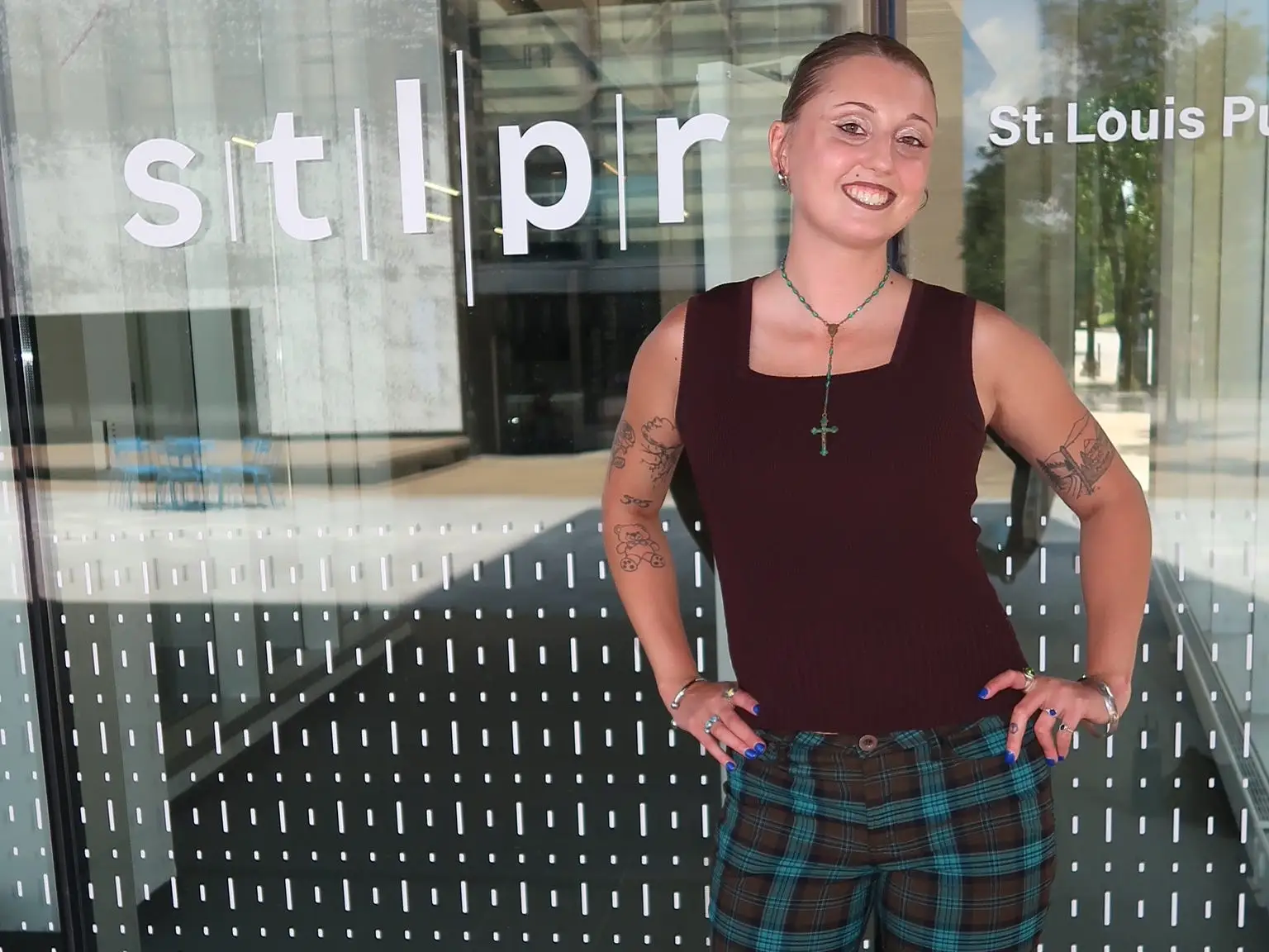 Hannah Valentine dressed in vintage attire: plaid pants and a red tank top.