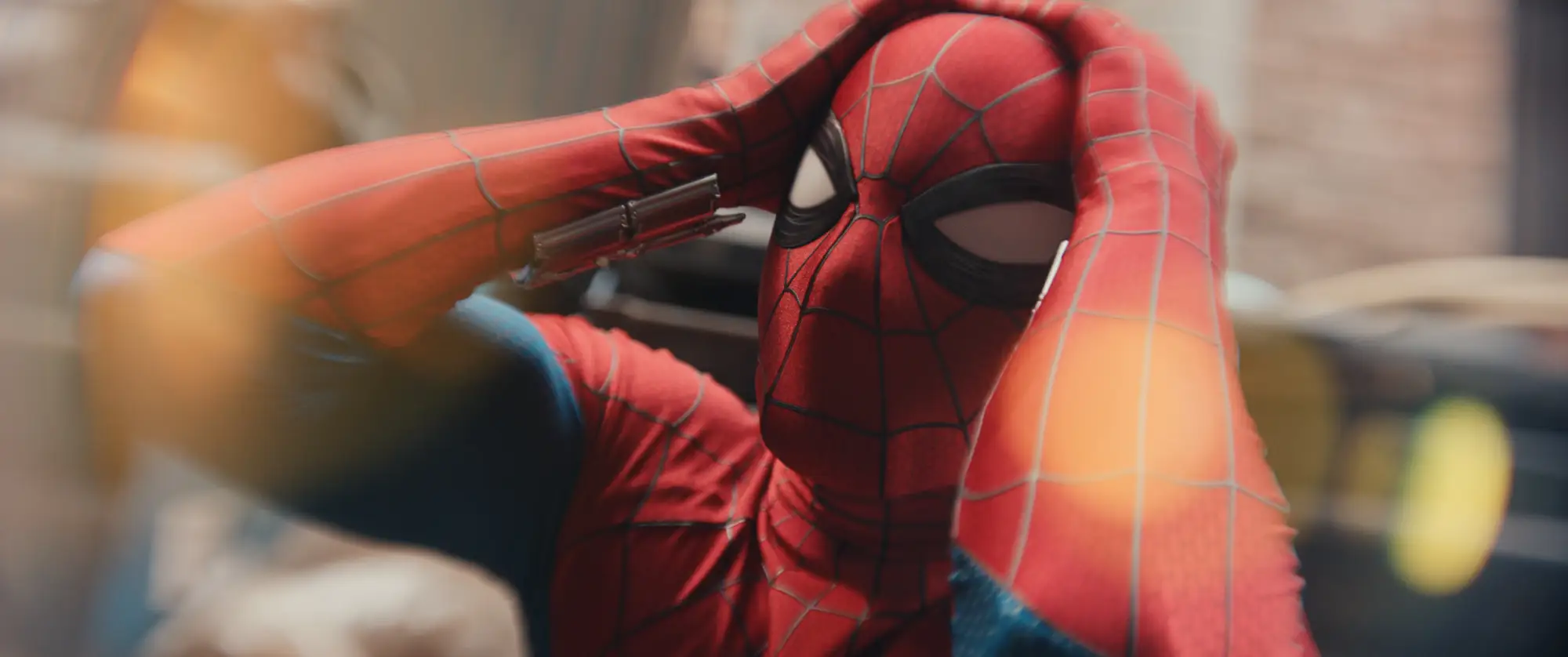 Spider-Man holding onto his head