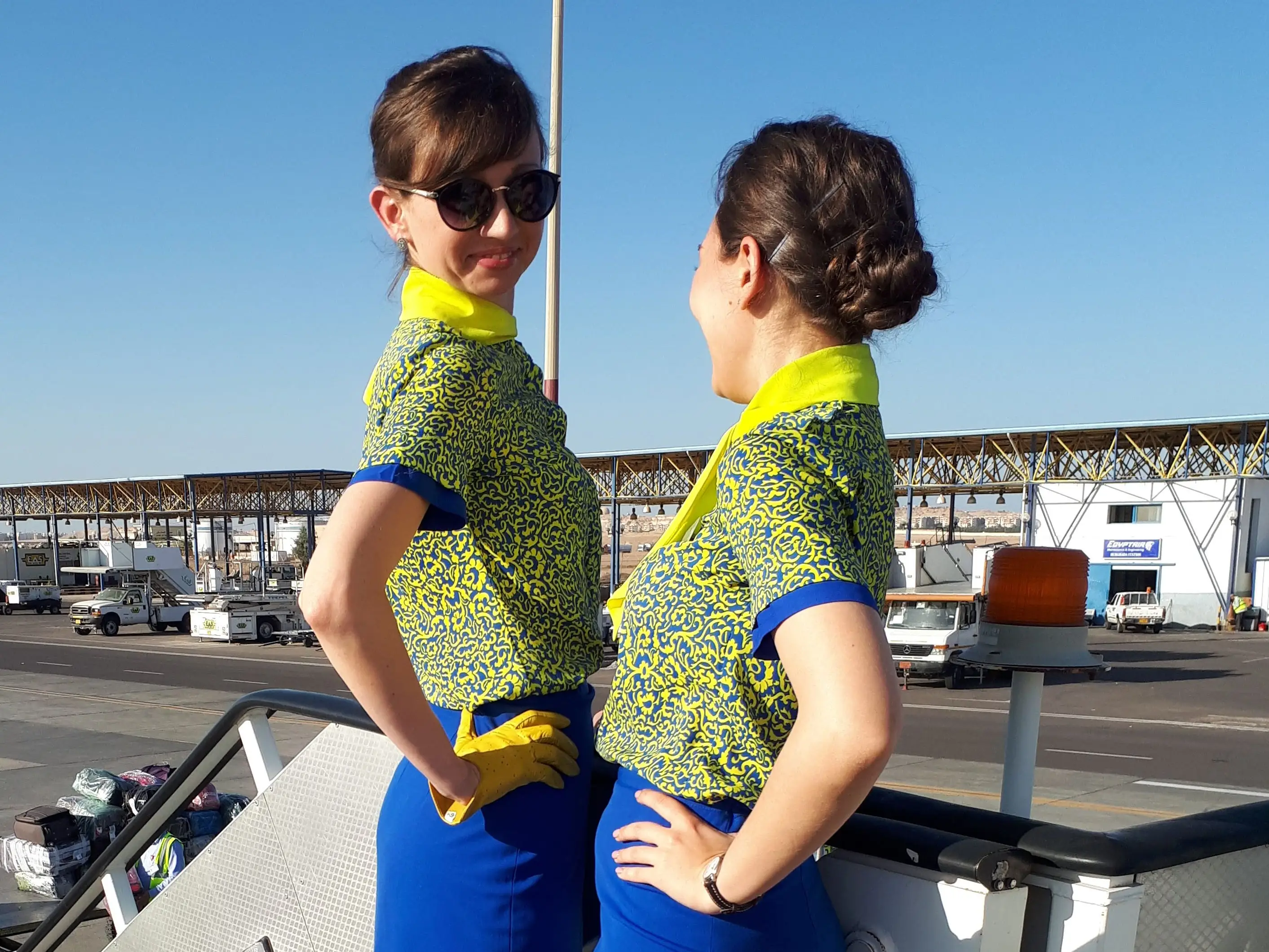 Flight attendants standing on airstairs.