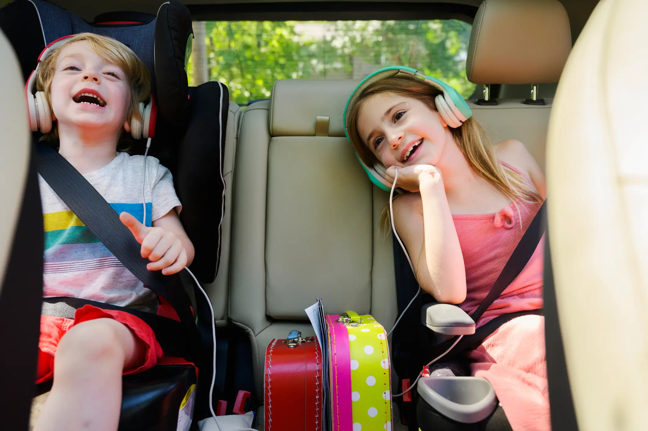 two kids with headphones in a car