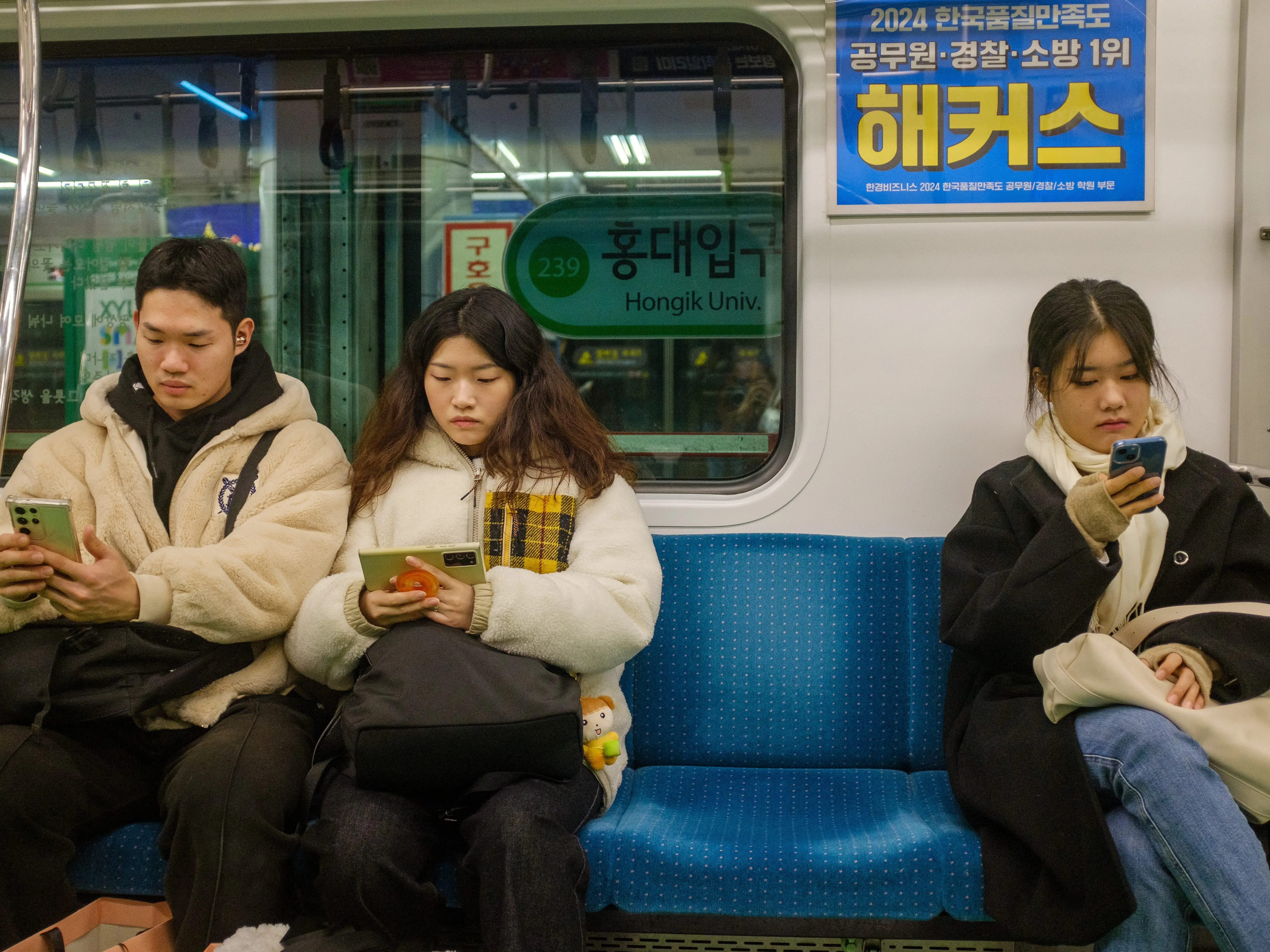 South Koreans on the subway using their phones.