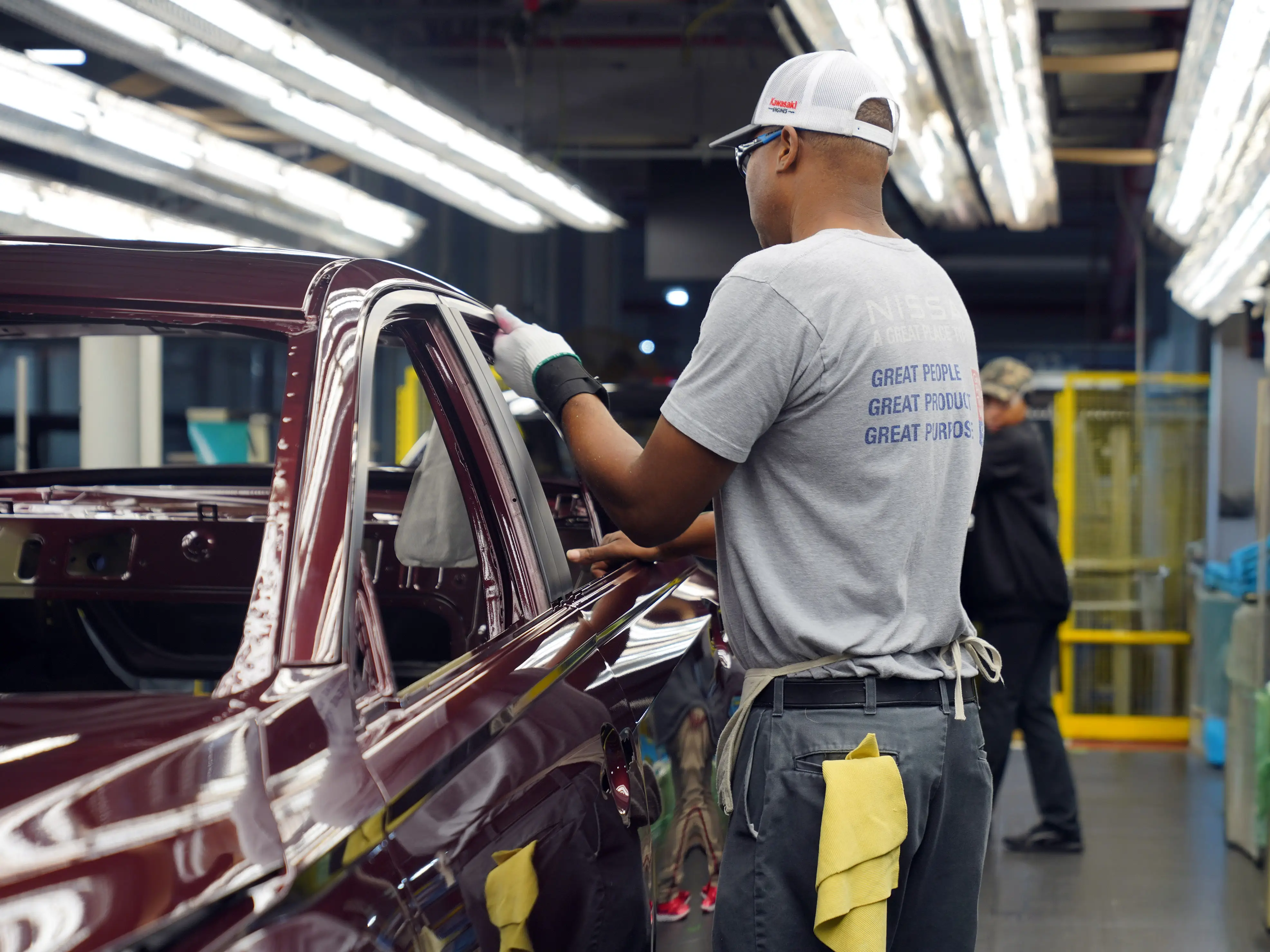 A Nissan employee works on an Altima sedan at the Canton, Mississippi assembly line.