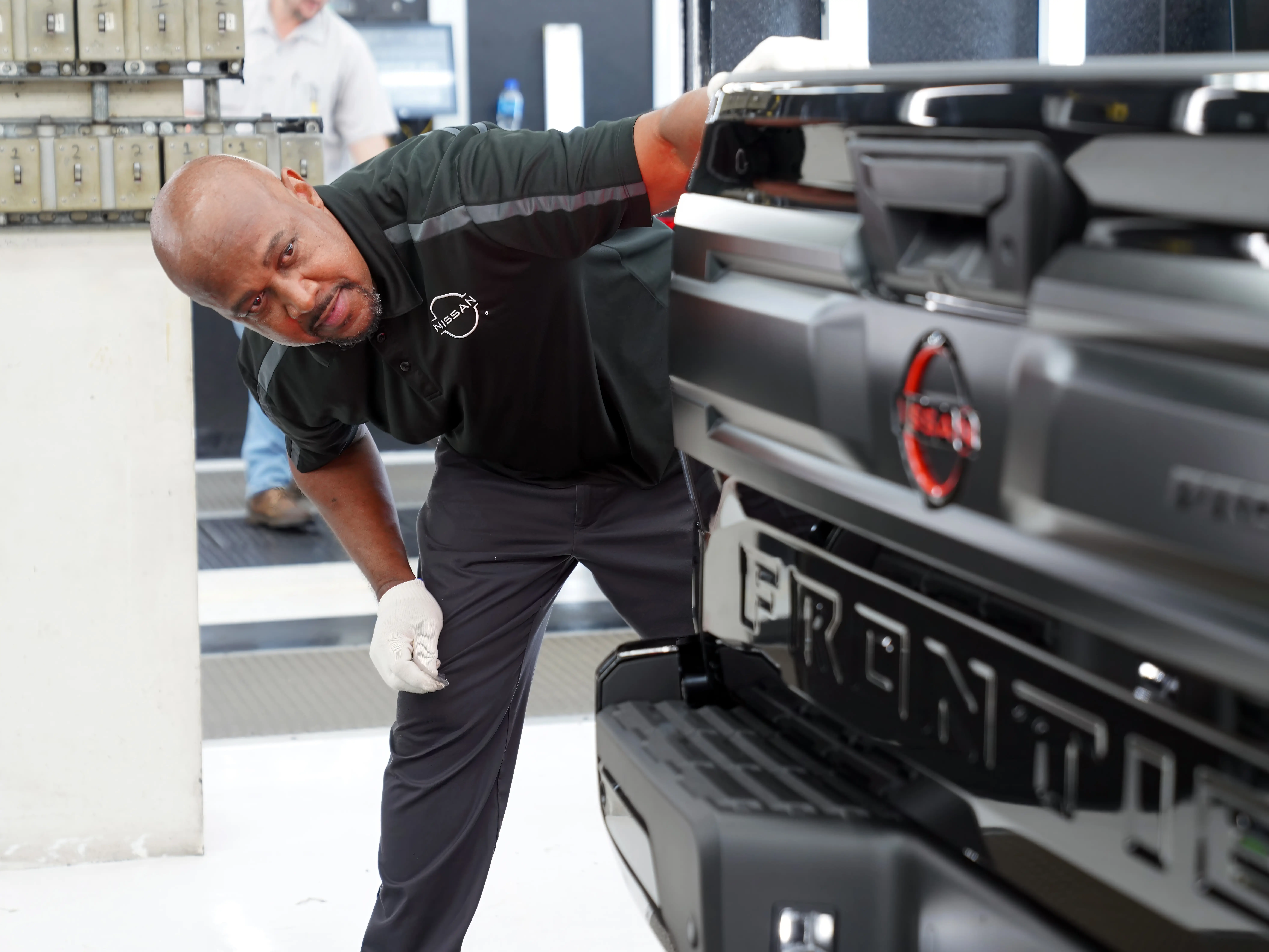 A Nissan employee works on an Altima sedan at the Canton, Mississippi assembly line.