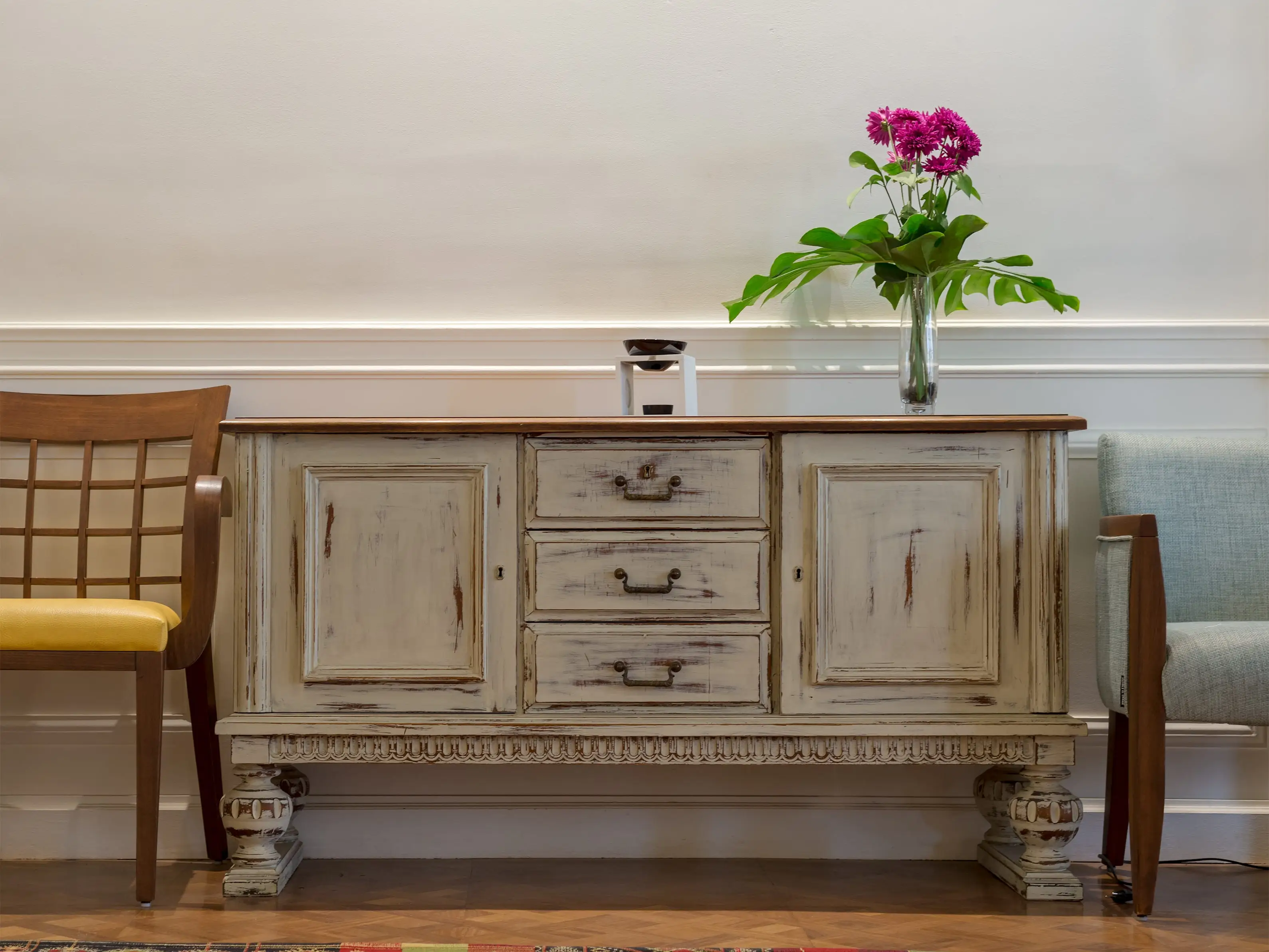 Wooden vintage off white sideboard, with vase on top