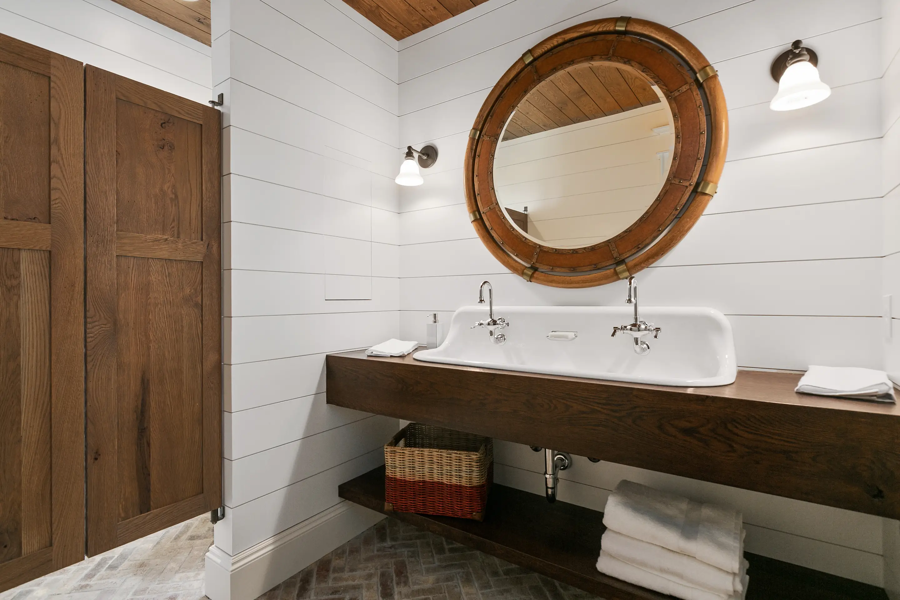 Bathroom with wood counter and mirror, white shiplap walls