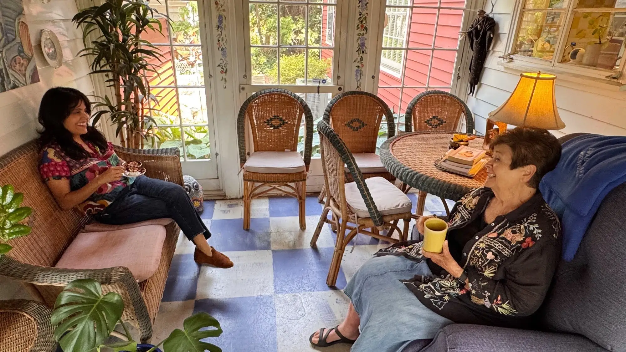 Woman talking with another woman who is holding a coffee mug