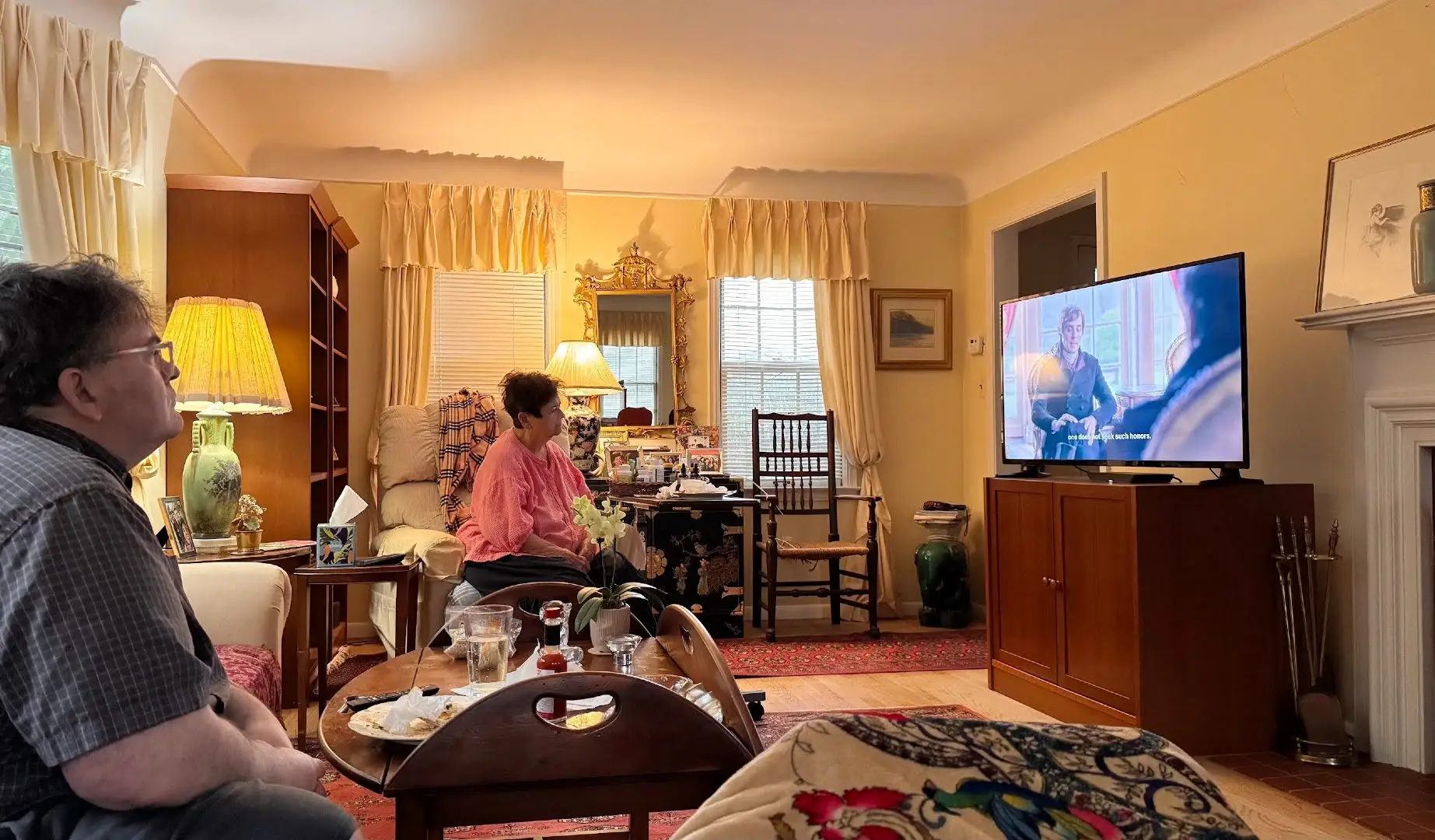 Woman watching television in living room
