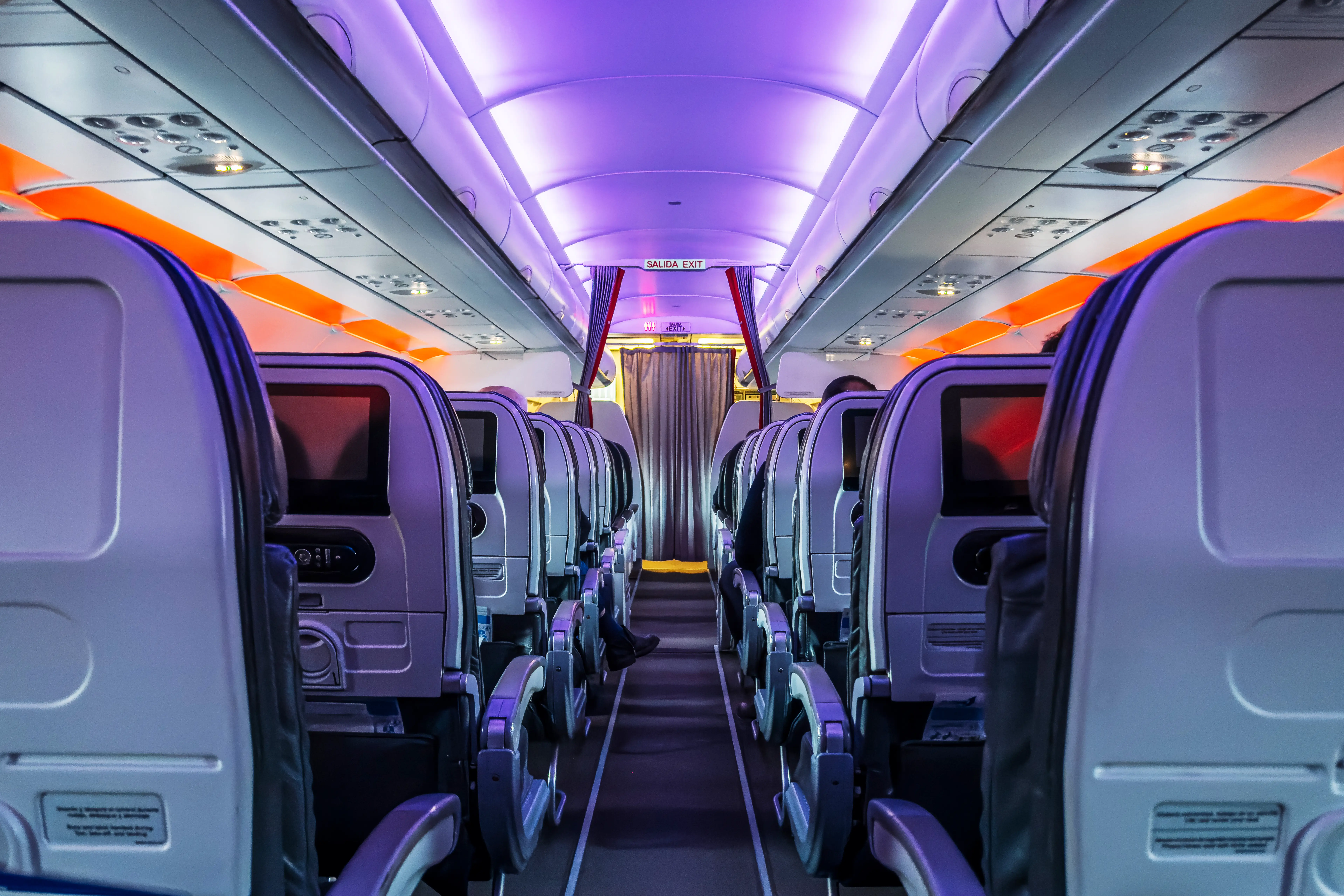 Interior of plane with purple and orange lighting