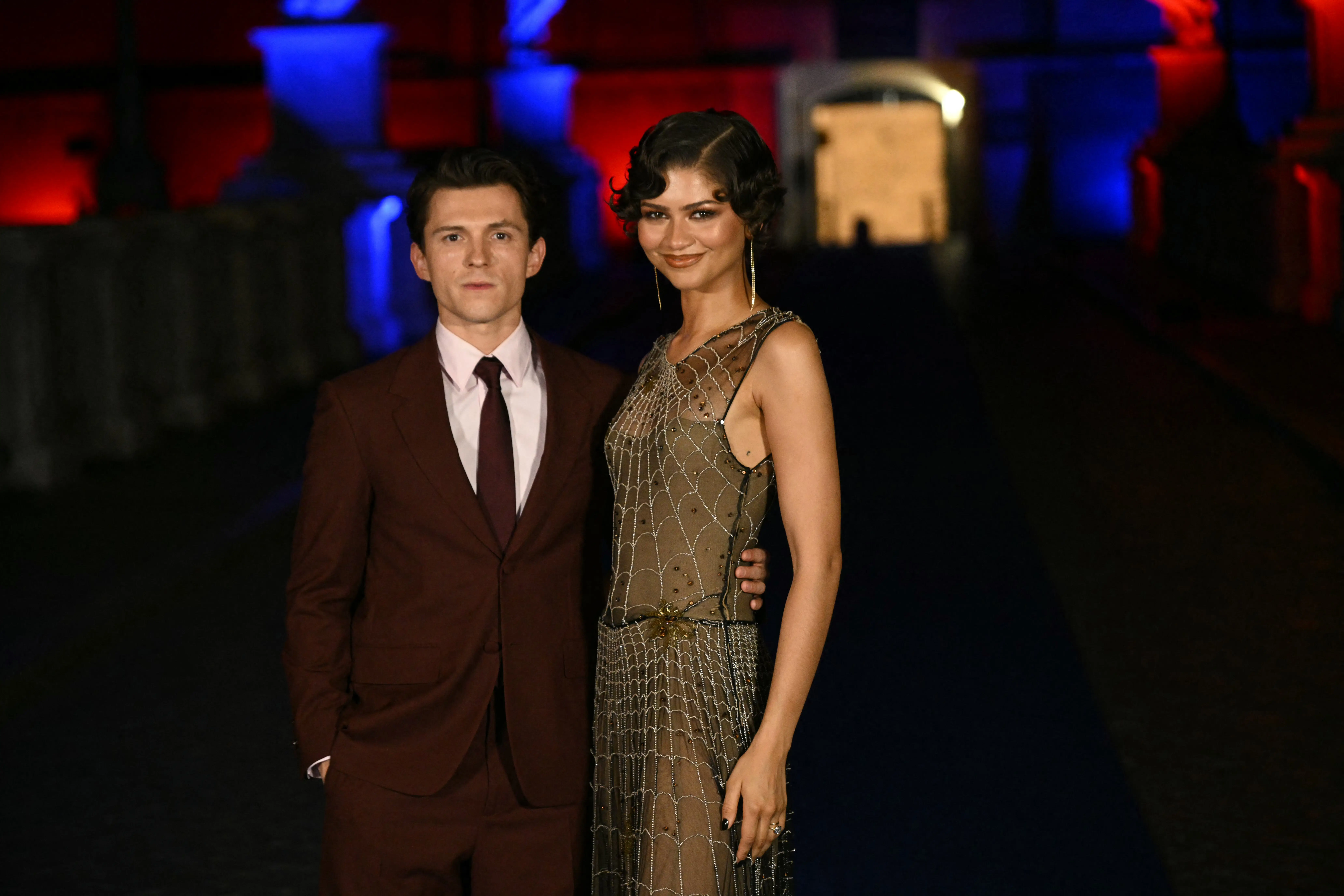 Actors Zendaya and Tom Holland pose on the bridge in front of Castel Sant'Angelo during a red carpet event for the film 
