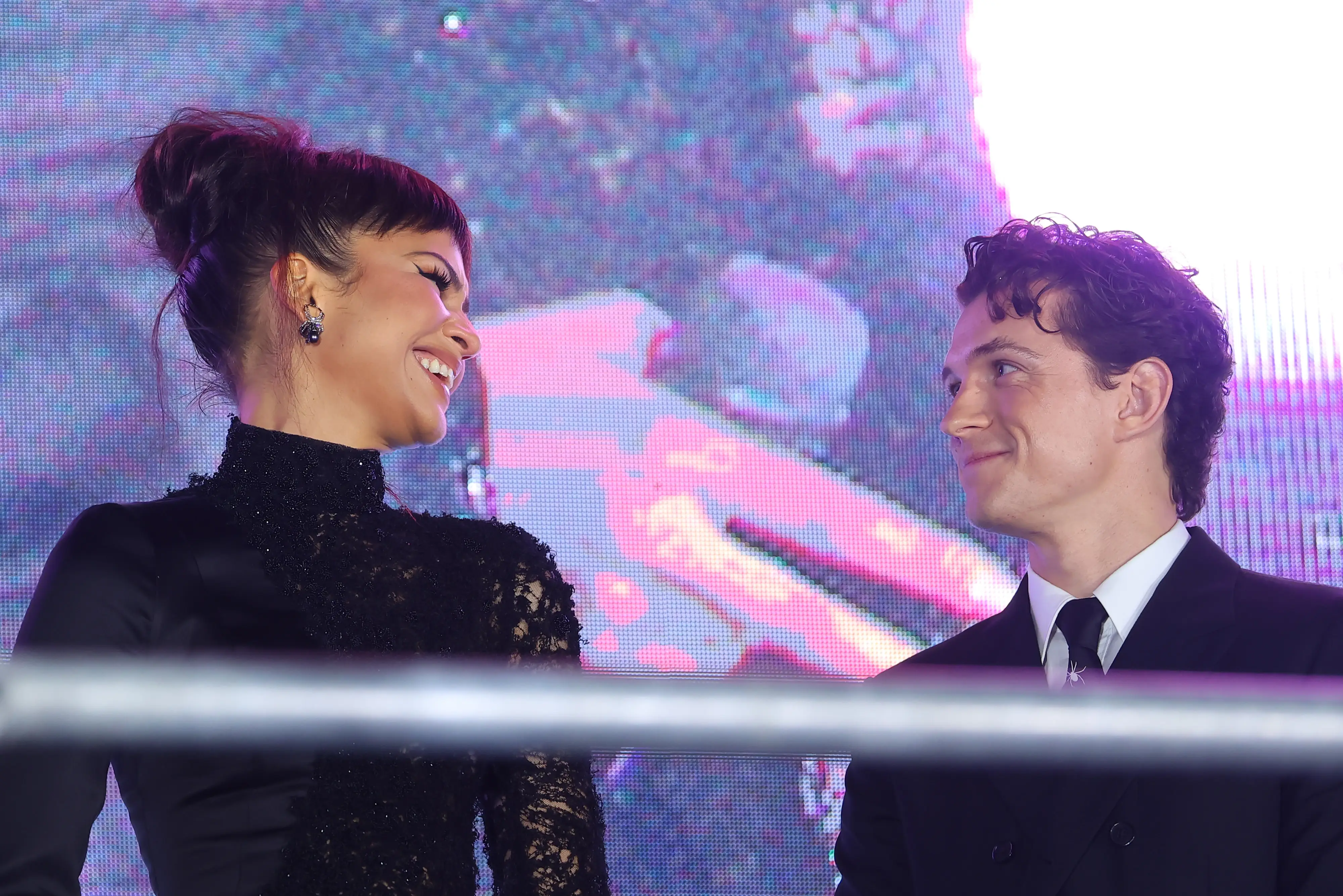 Zendaya and Tom Holland look at each other during the 