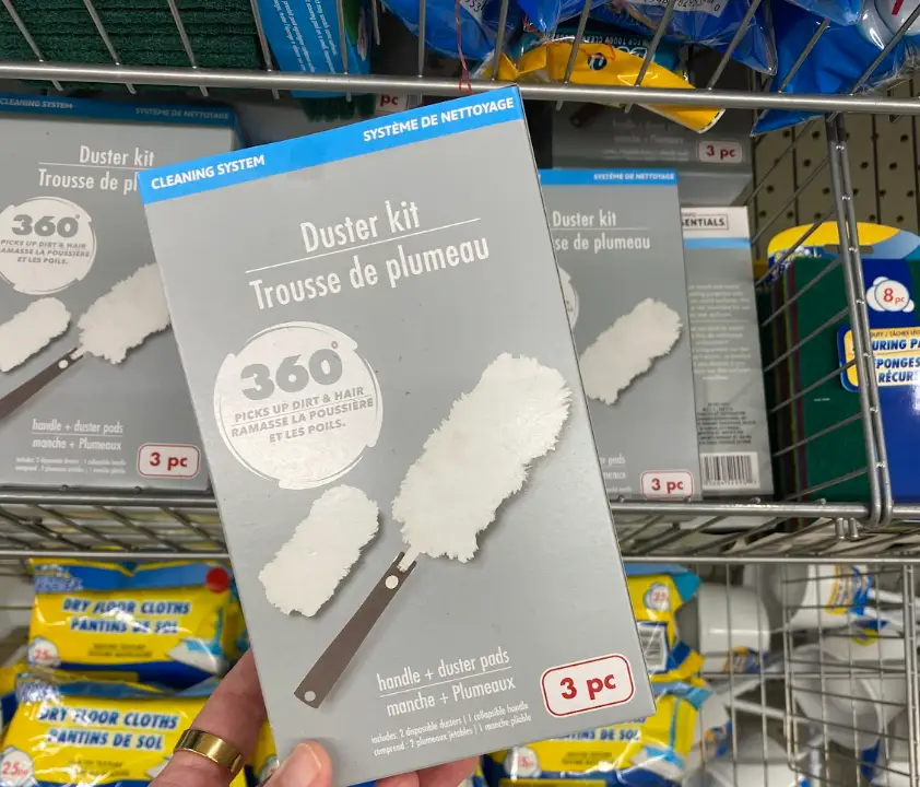 The writer holding up a three-pack of 360 duster kits at Dollar Tree.
