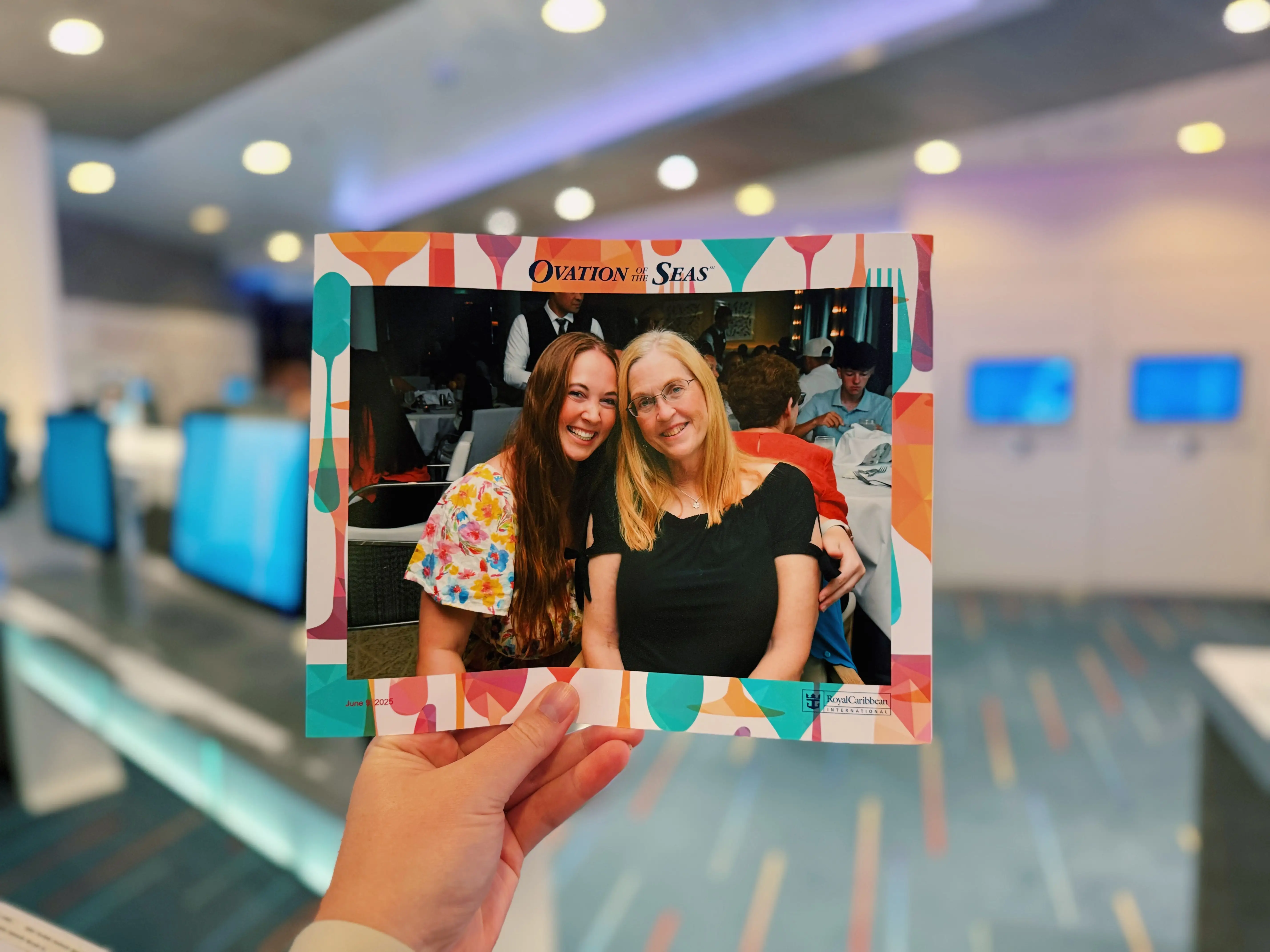 Hand holding professional photo of author and mom from Ovation of the Seas