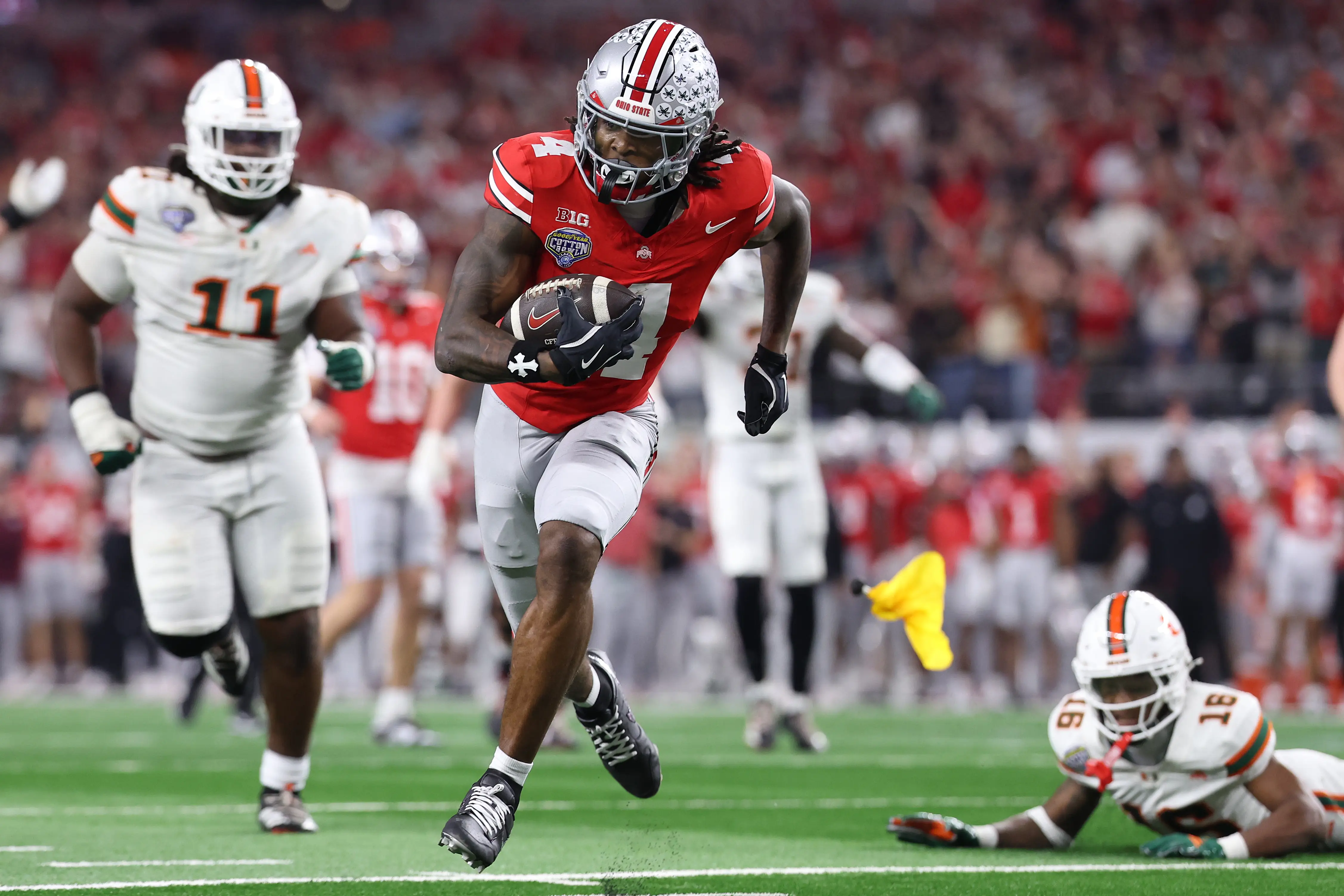 Jeremiah Smith #4 of the Ohio State Buckeyes runs for a fourth-quarter touchdown against the Miami Hurricanes.