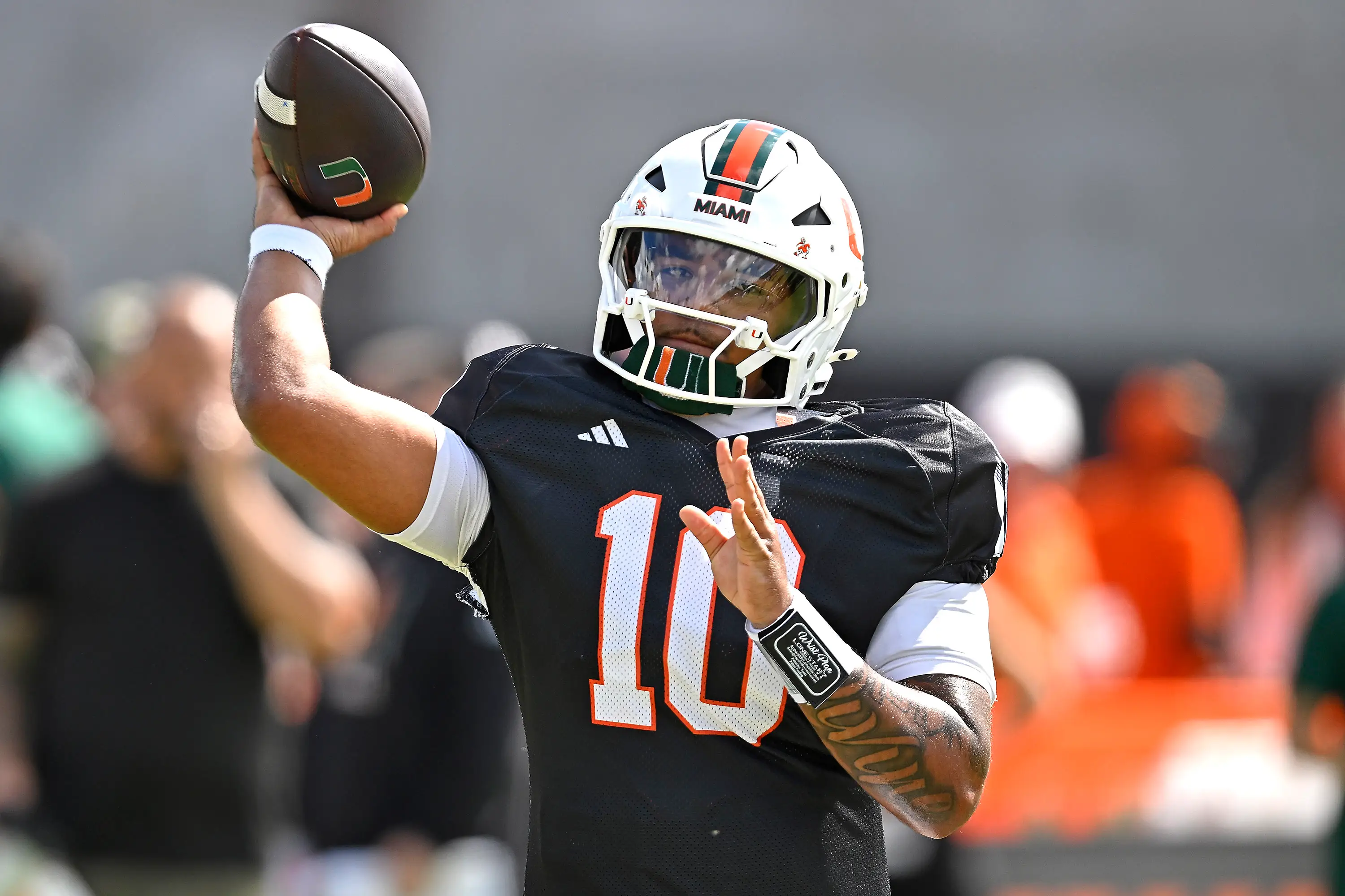 Miami quarterback Darian Mensah (10) runs through drills prior to the Miami Hurricanes playing their spring game.