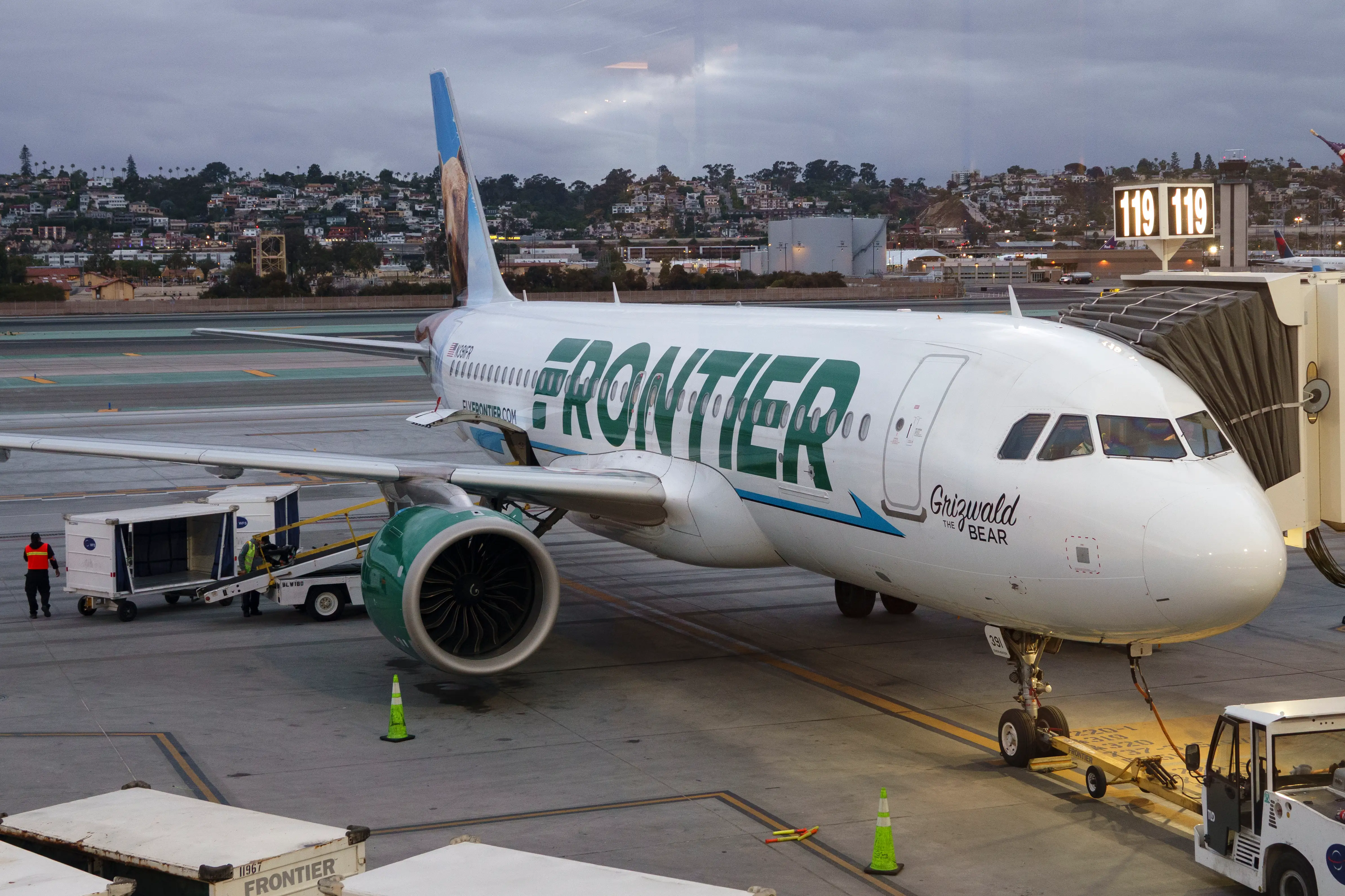 Frontier airlines plane at a gate.