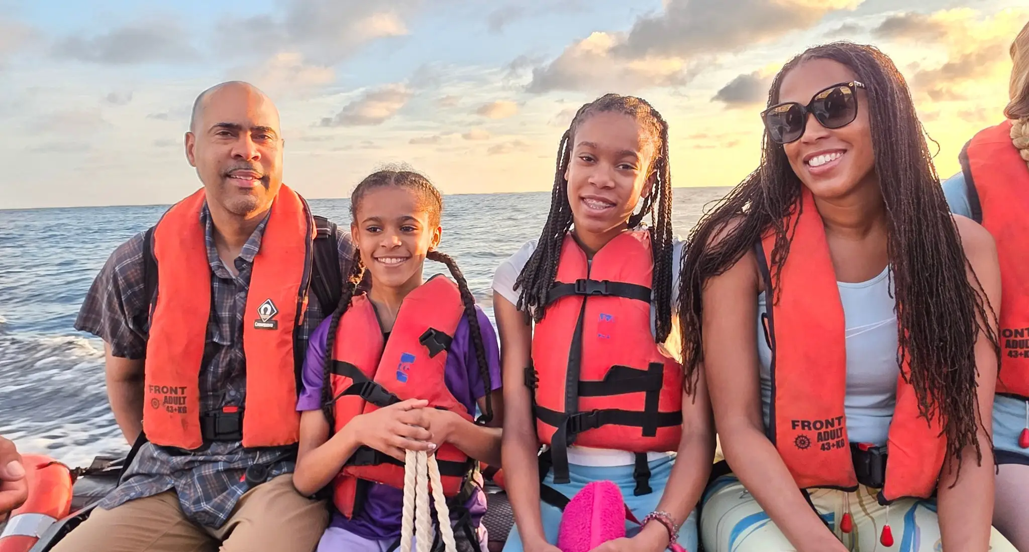 The author and her family wearing life vests sitting on a zodiac.