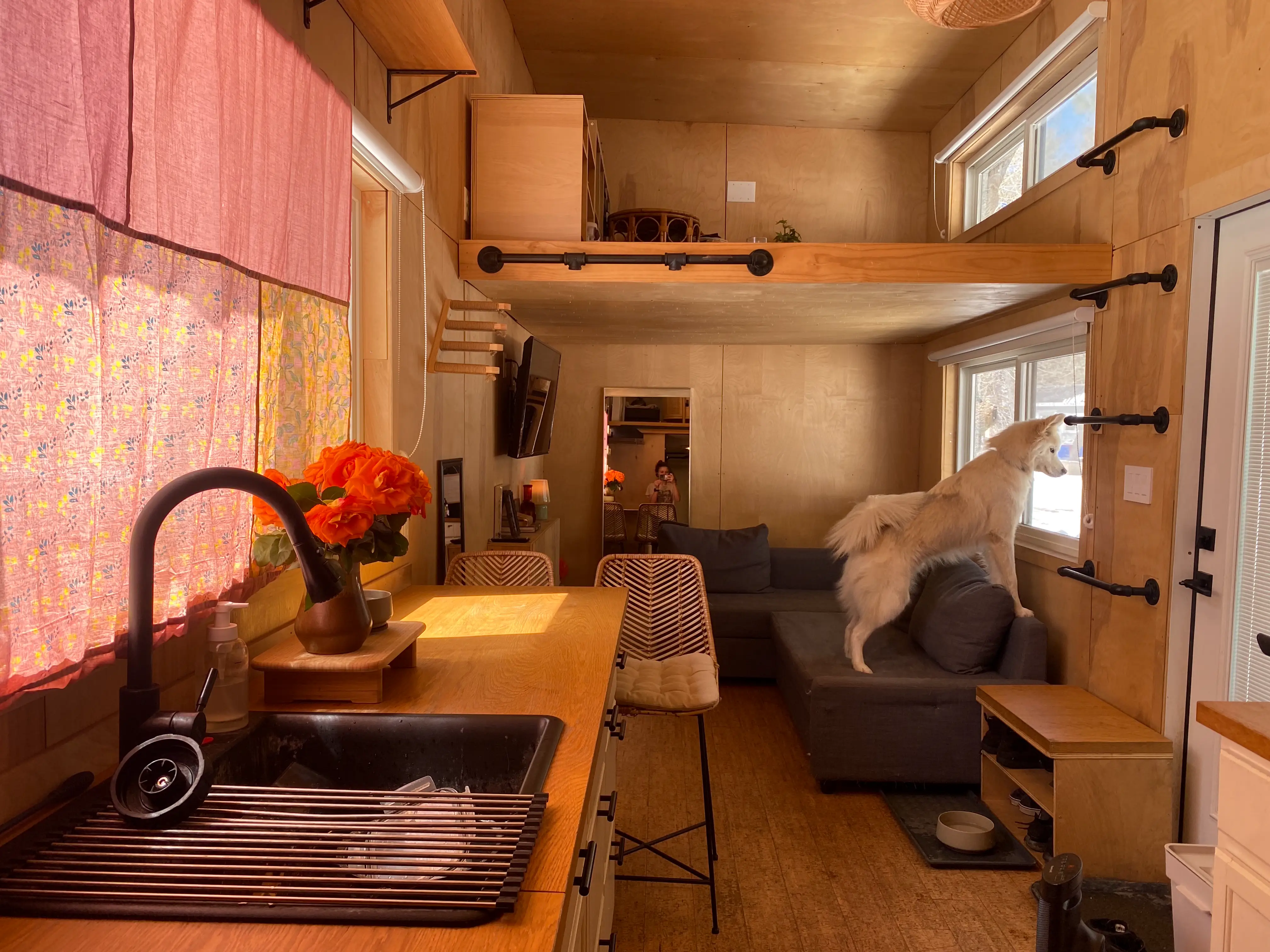 Interior of tiny home with kitchen area, loft area