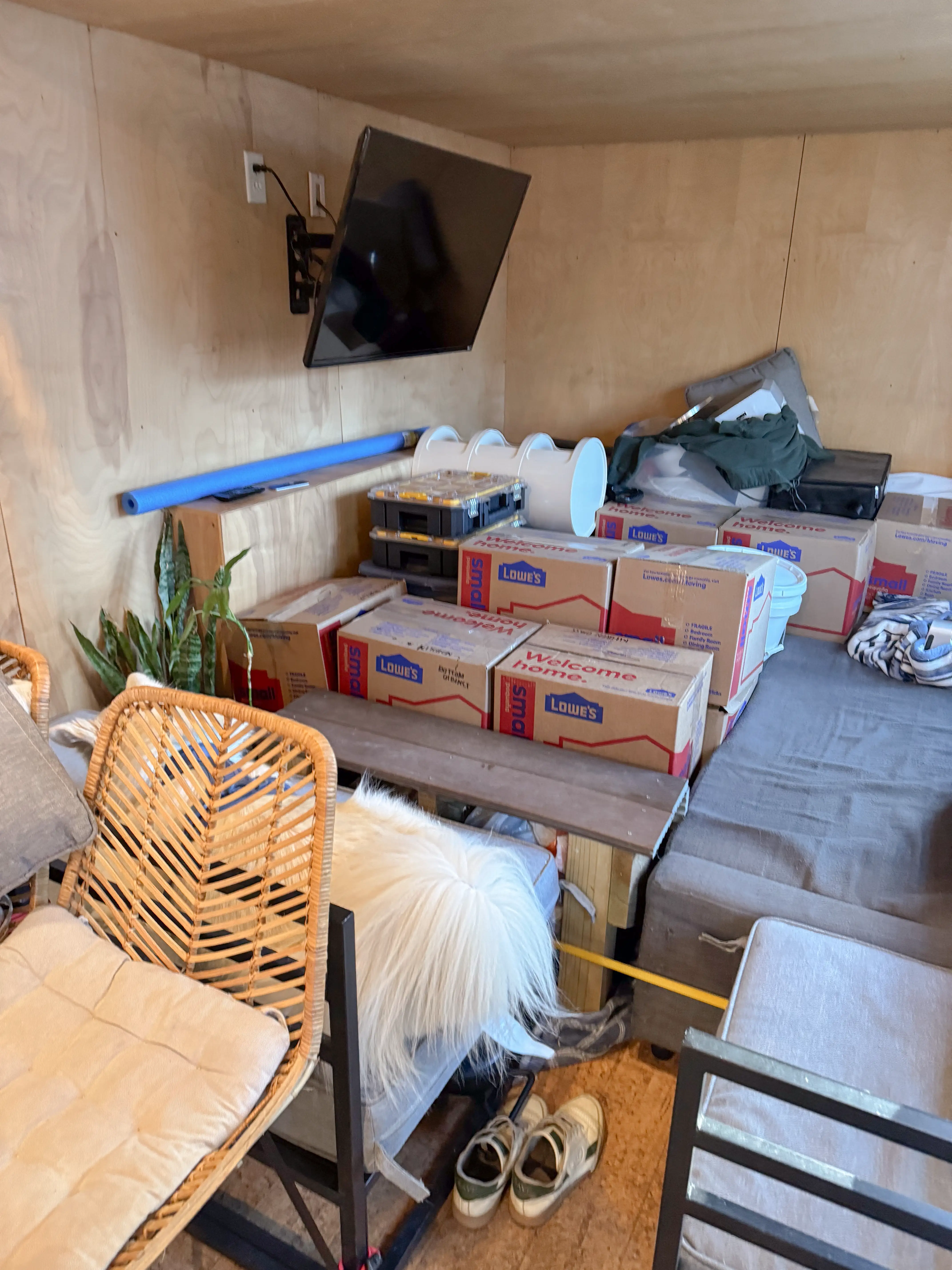 Boxes stacked inside home with furniture around them
