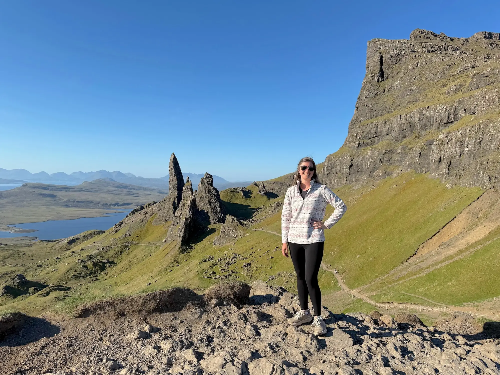 The author poses on a ridge in Scotland during a road trip.
