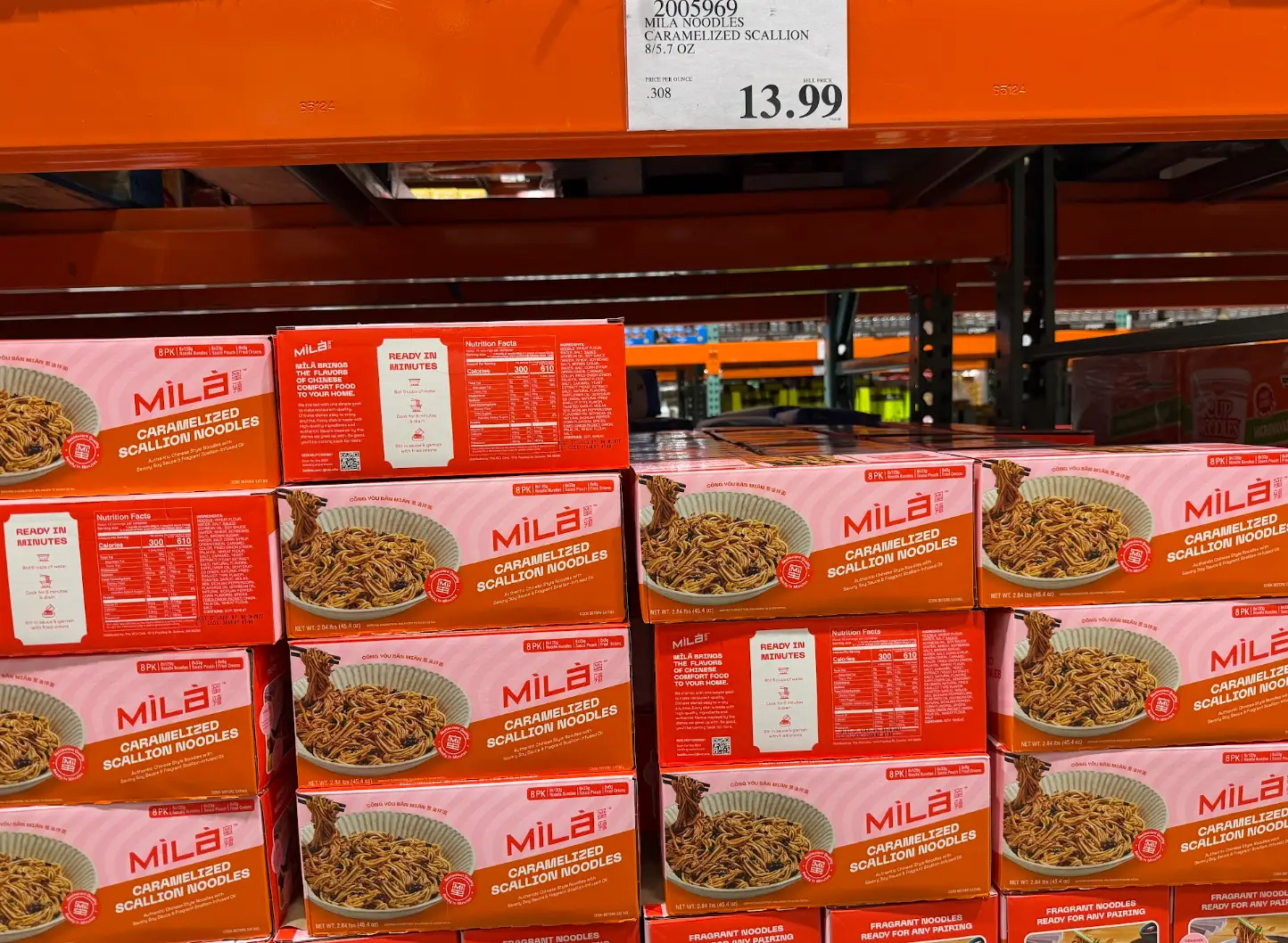 A display of boxes of caramelized scallion noodles from Costco.