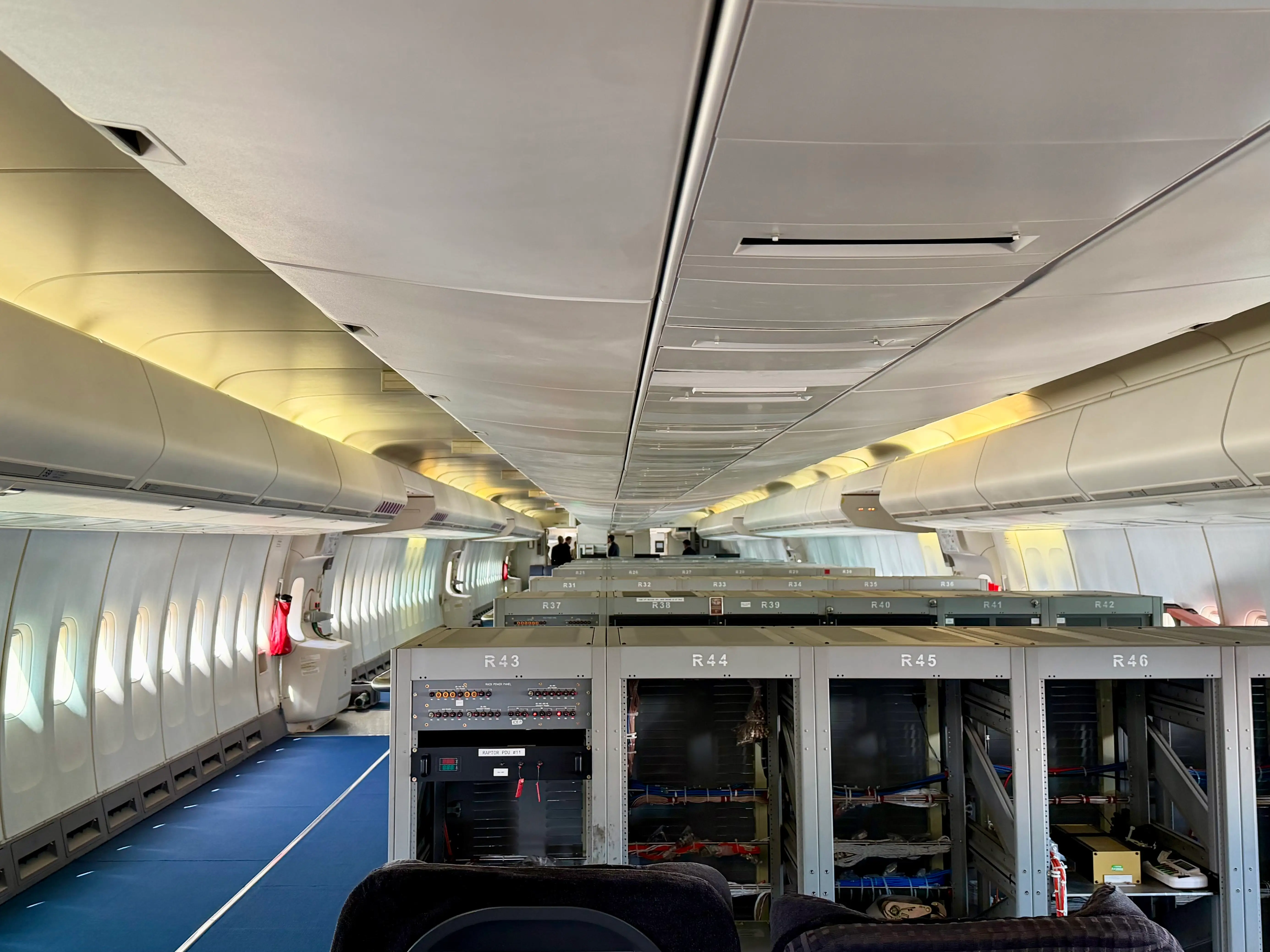 The rows of silver boxes in the GE 747 cabin.