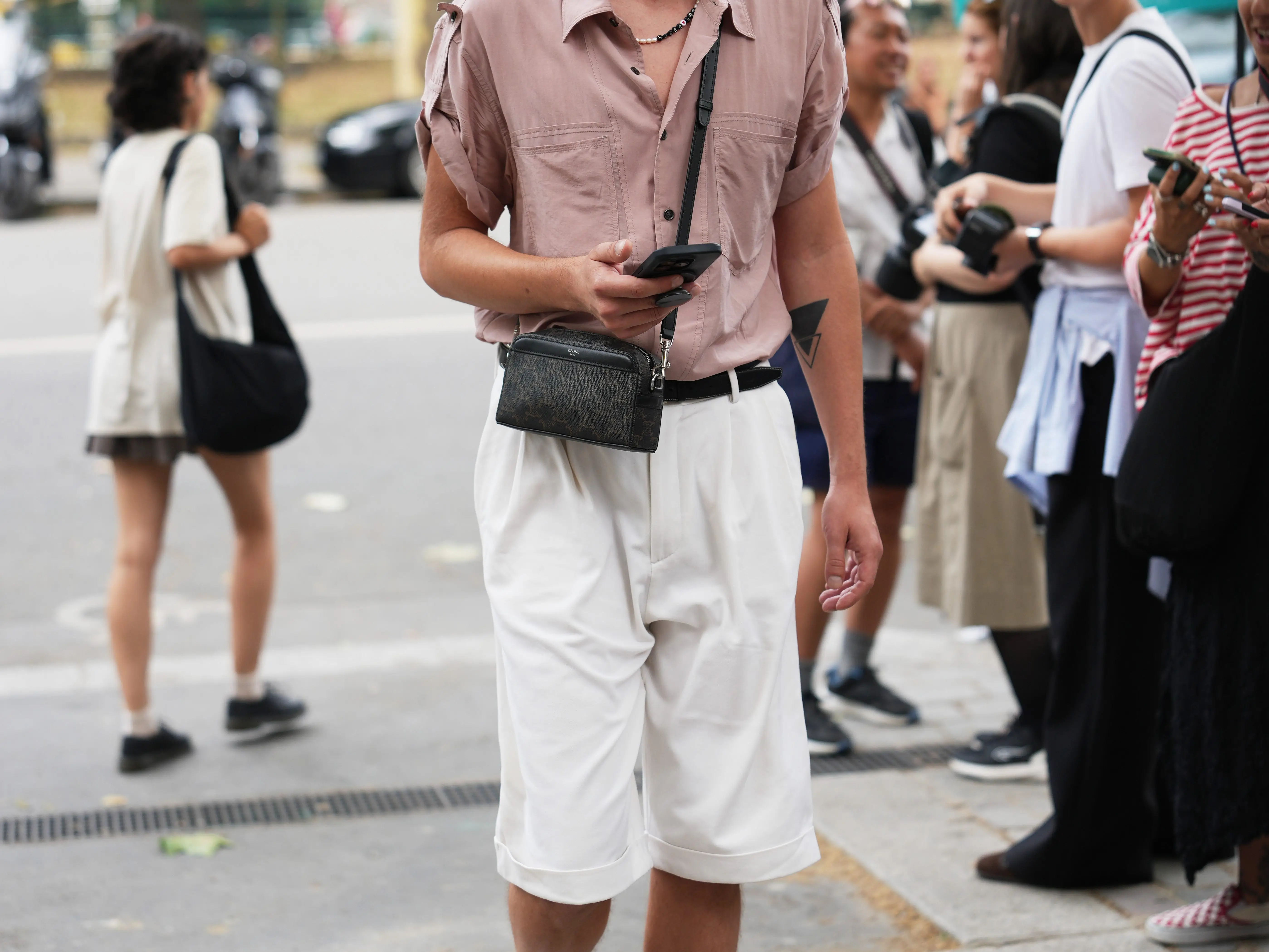 A man wears tan trouser shorts during Paris Fashion Week.