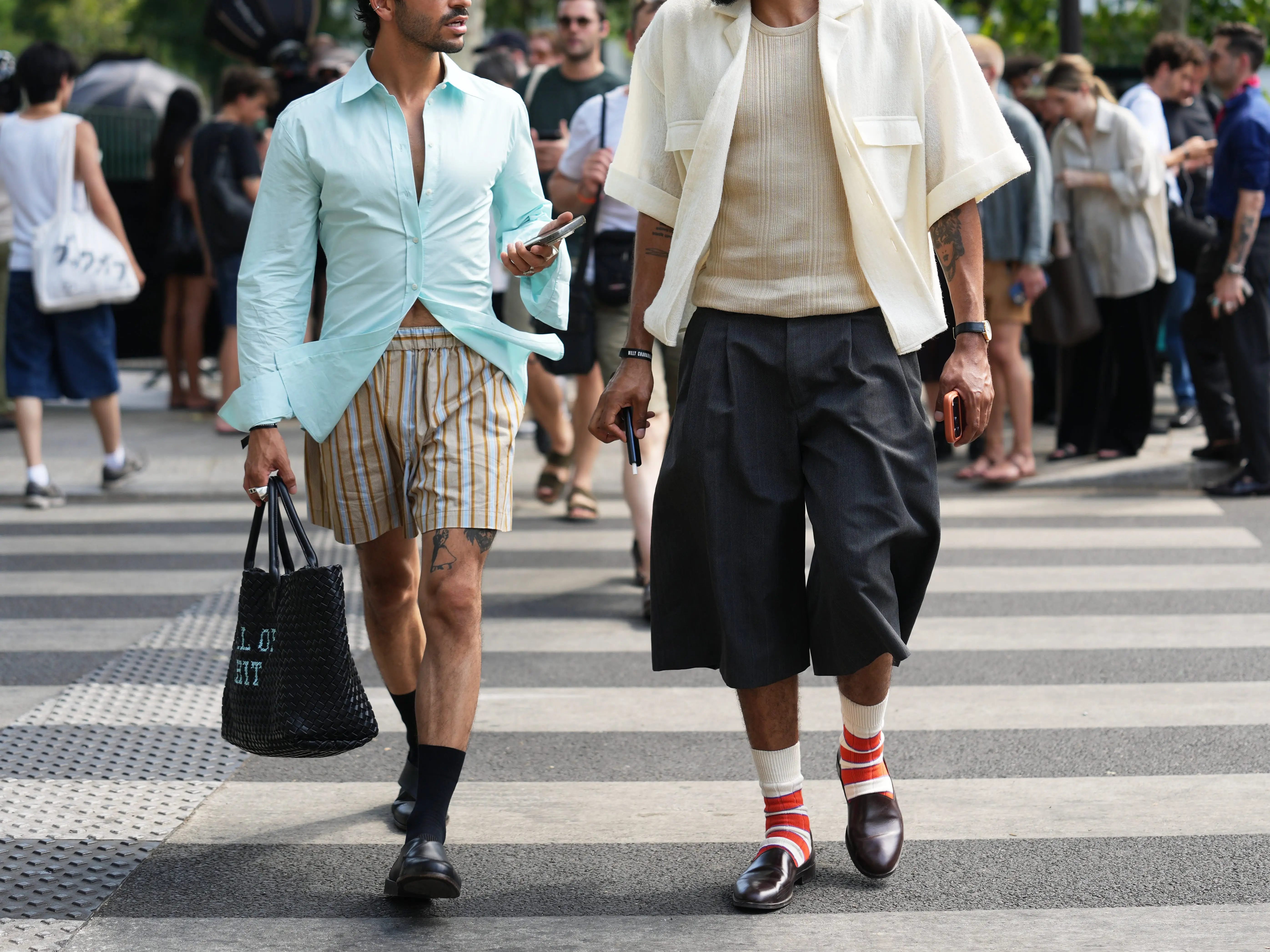 Men wear two different styles of shorts with ankle socks and loafers.
