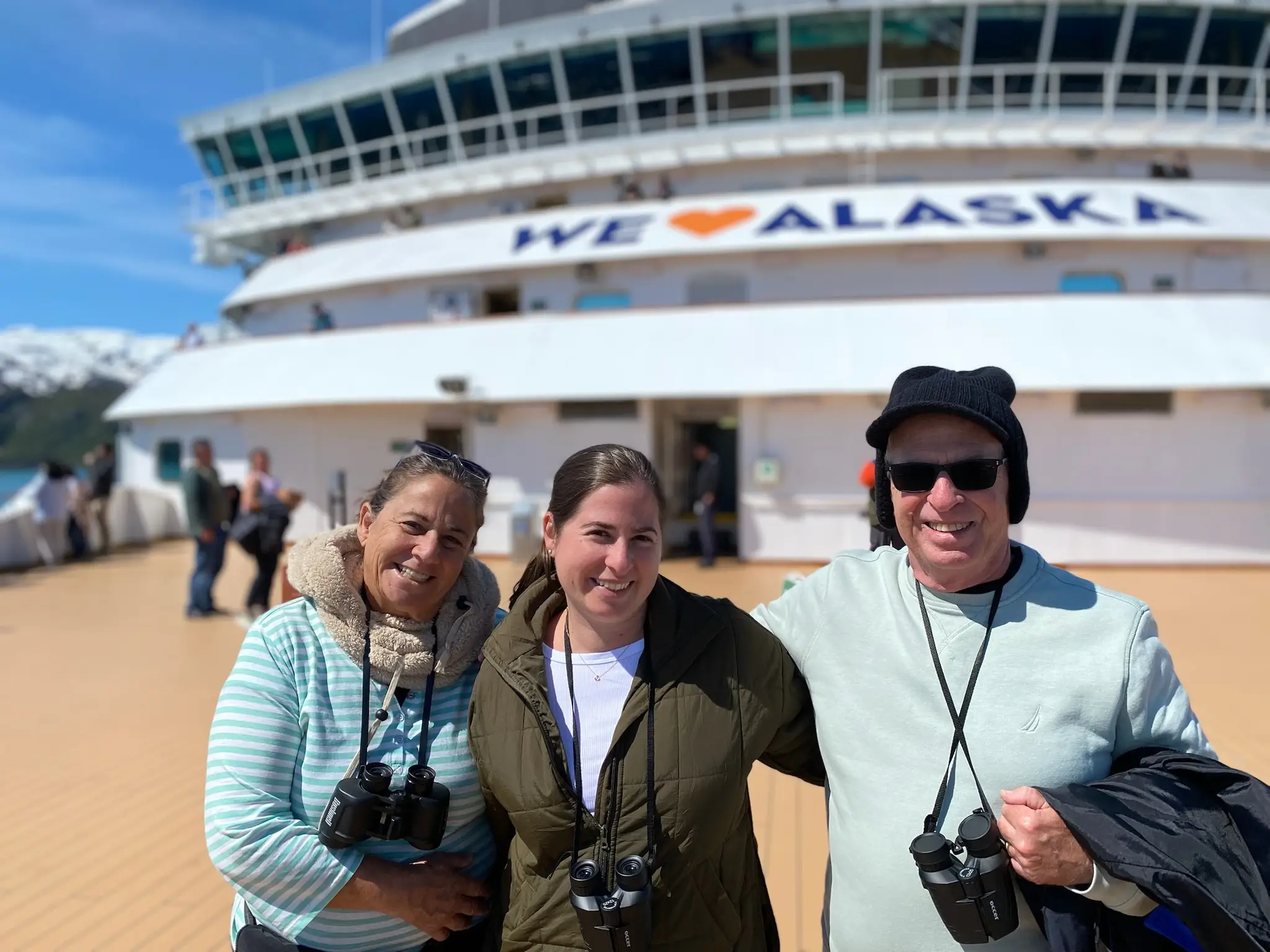Three people smiling on cruise ship