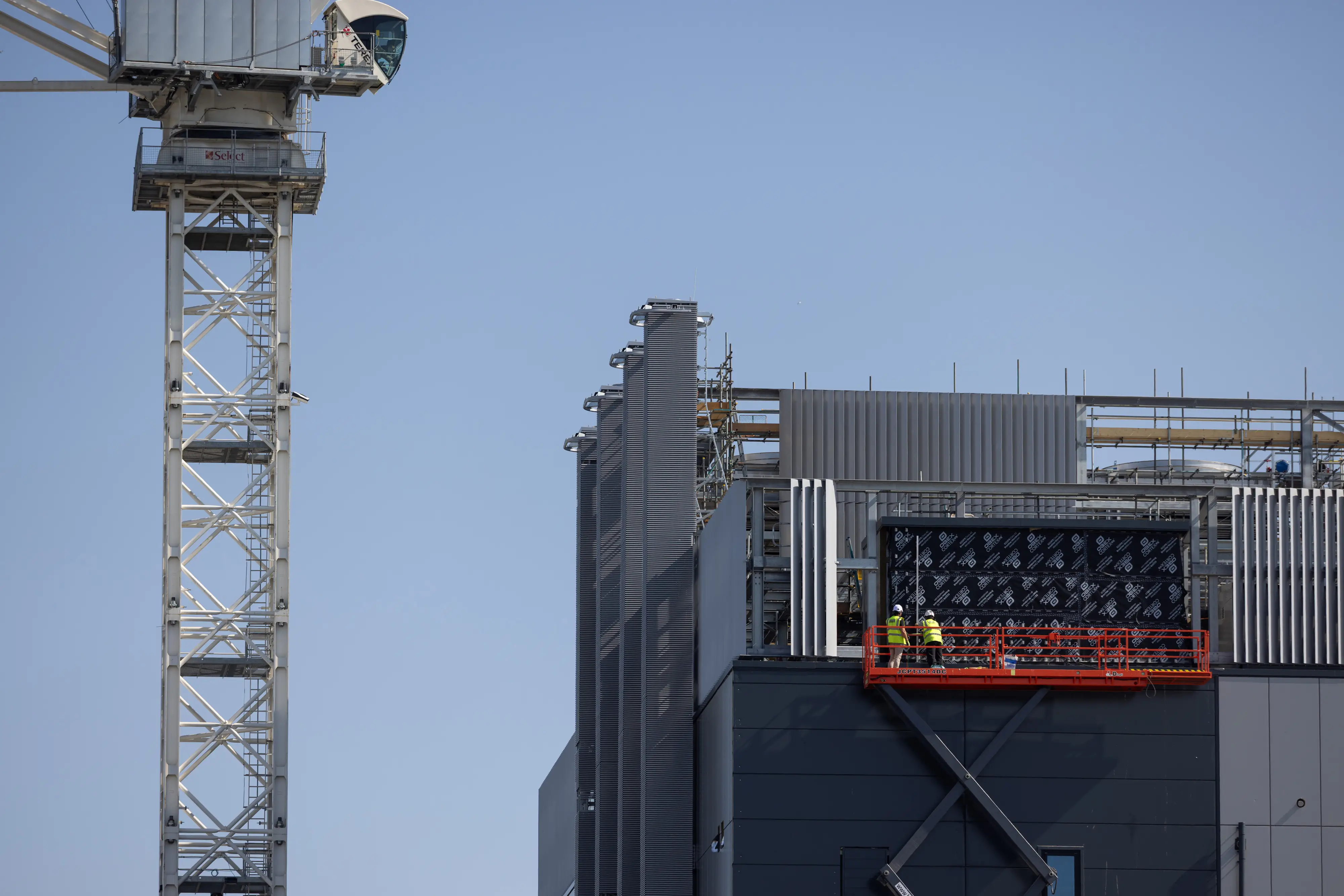 Workers outside a data center during construction in Slough, UK