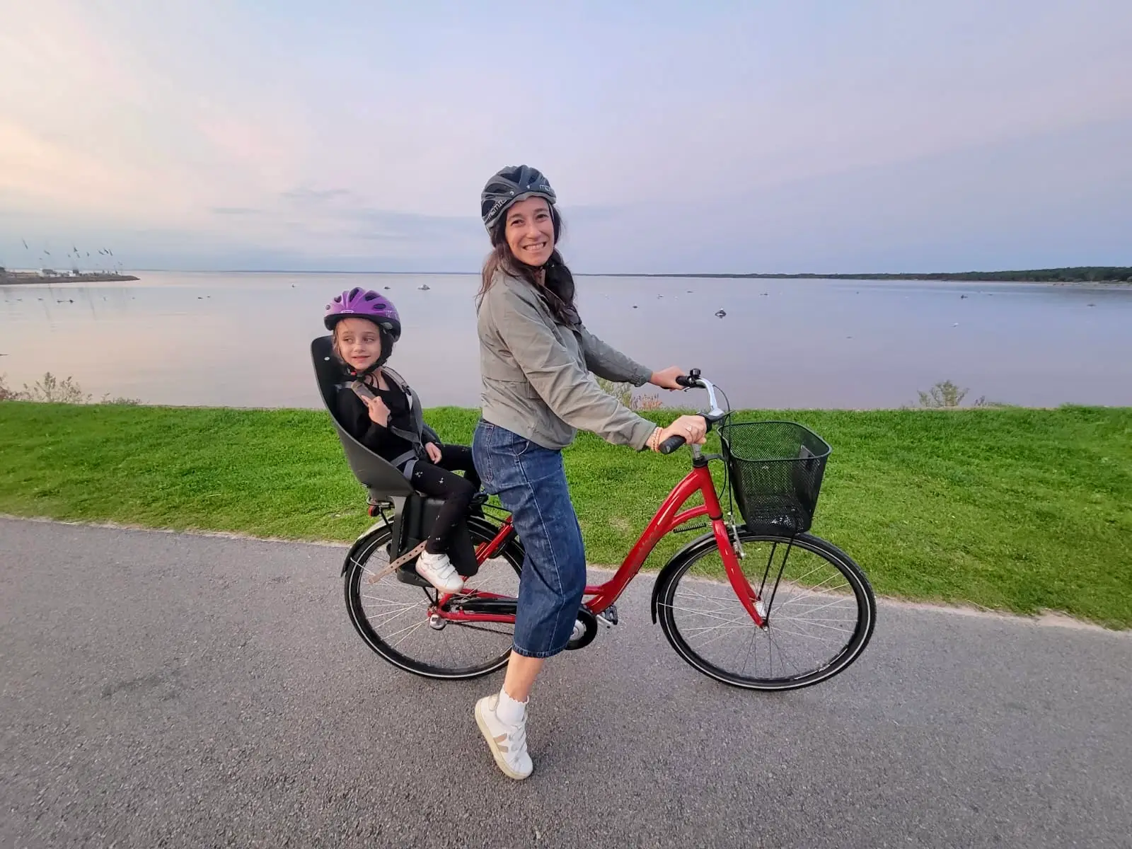 woman on bicycle with child in carrier