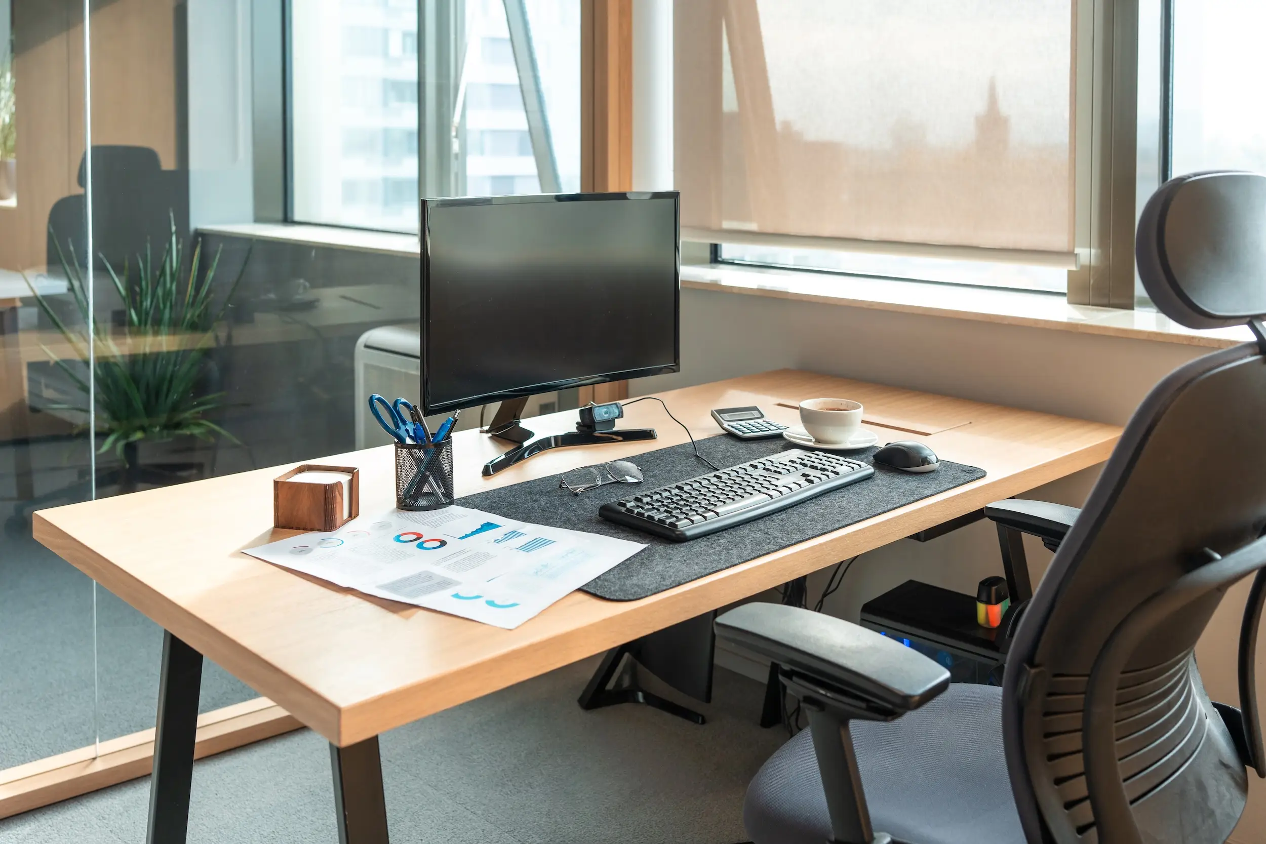 An empty desk and a blank computer screen.