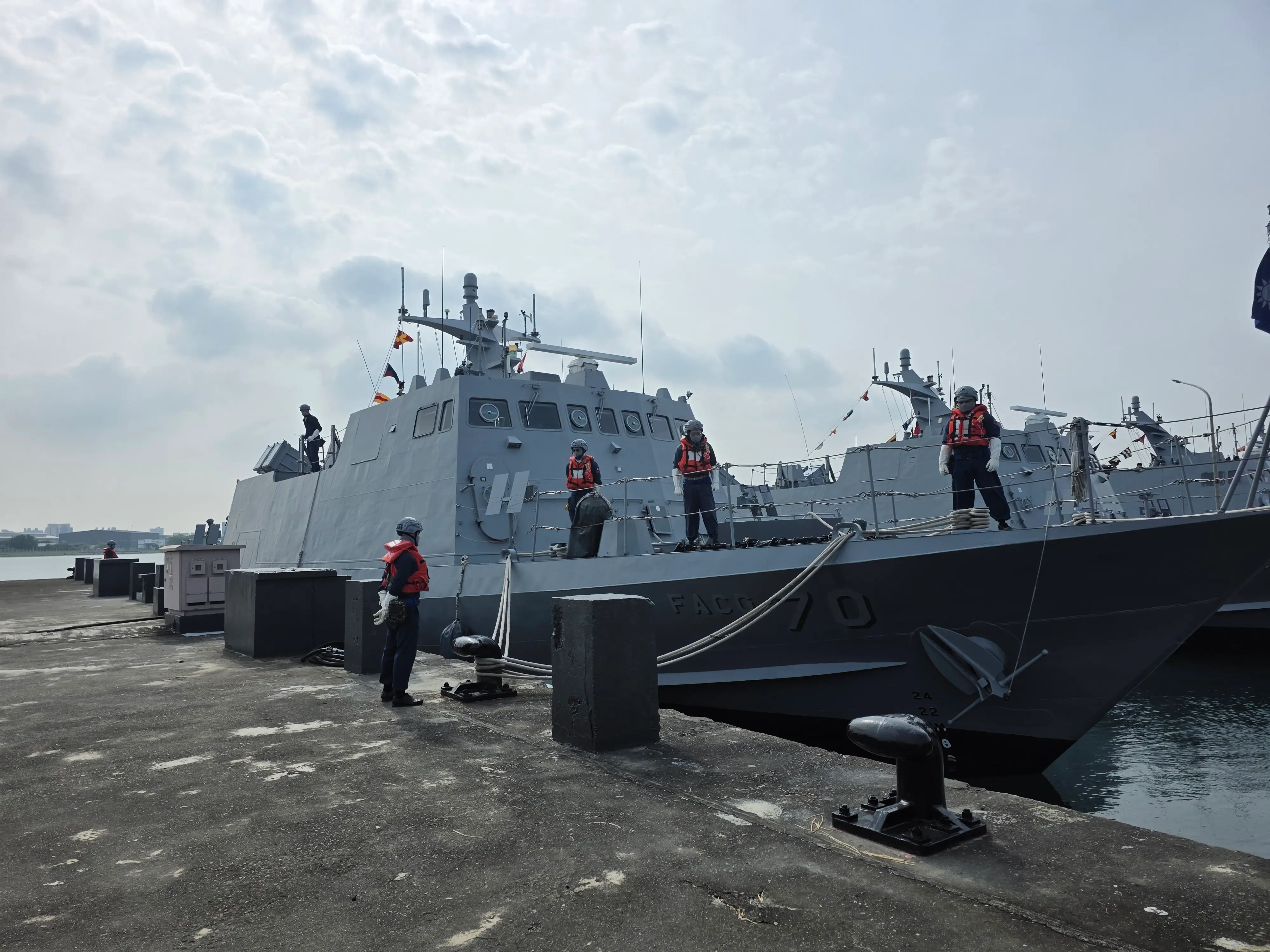 Sailors aboard a Kuang-6 missile boat prepare to set sail.