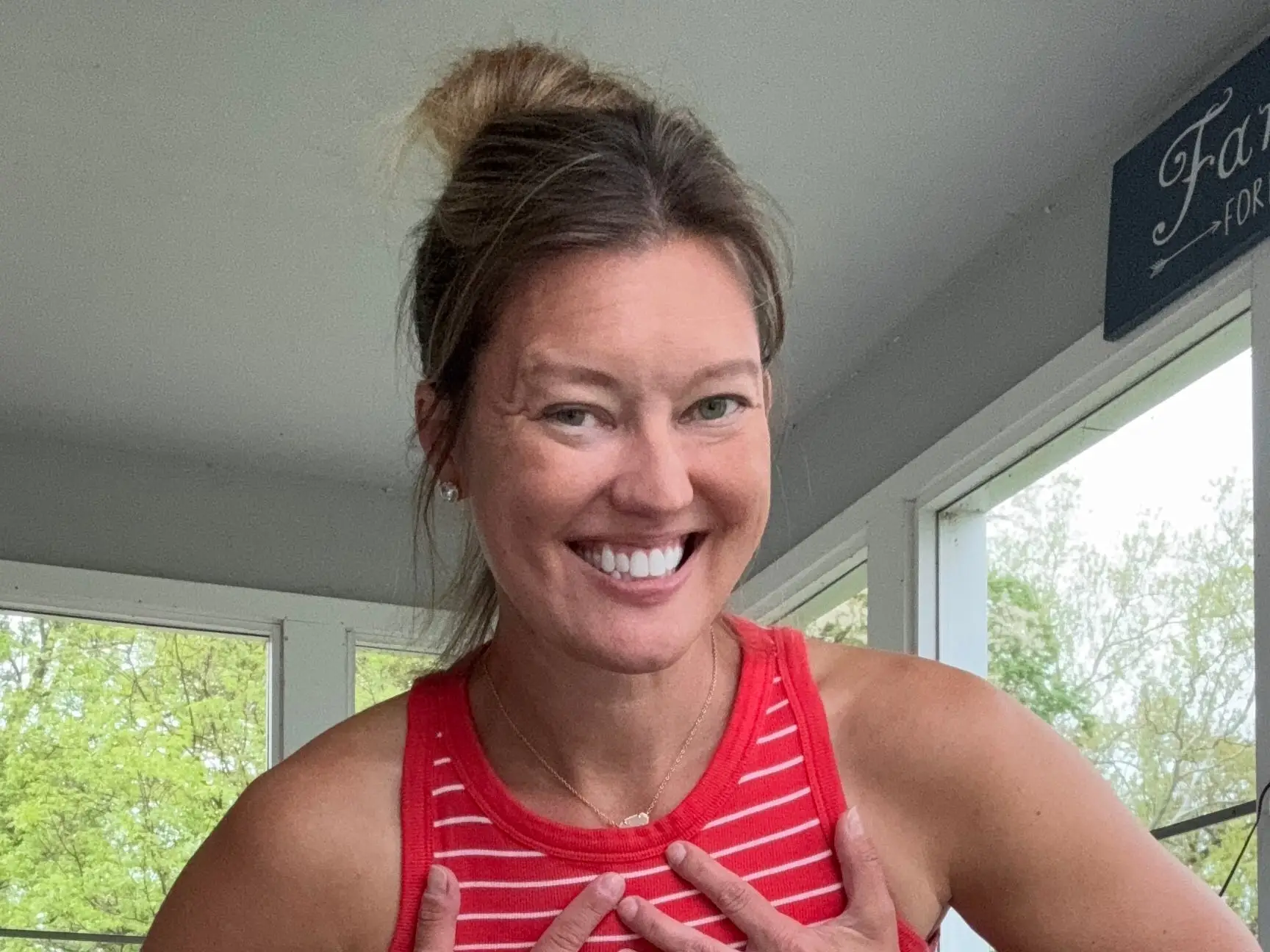 The author smiles and poses inside a home.