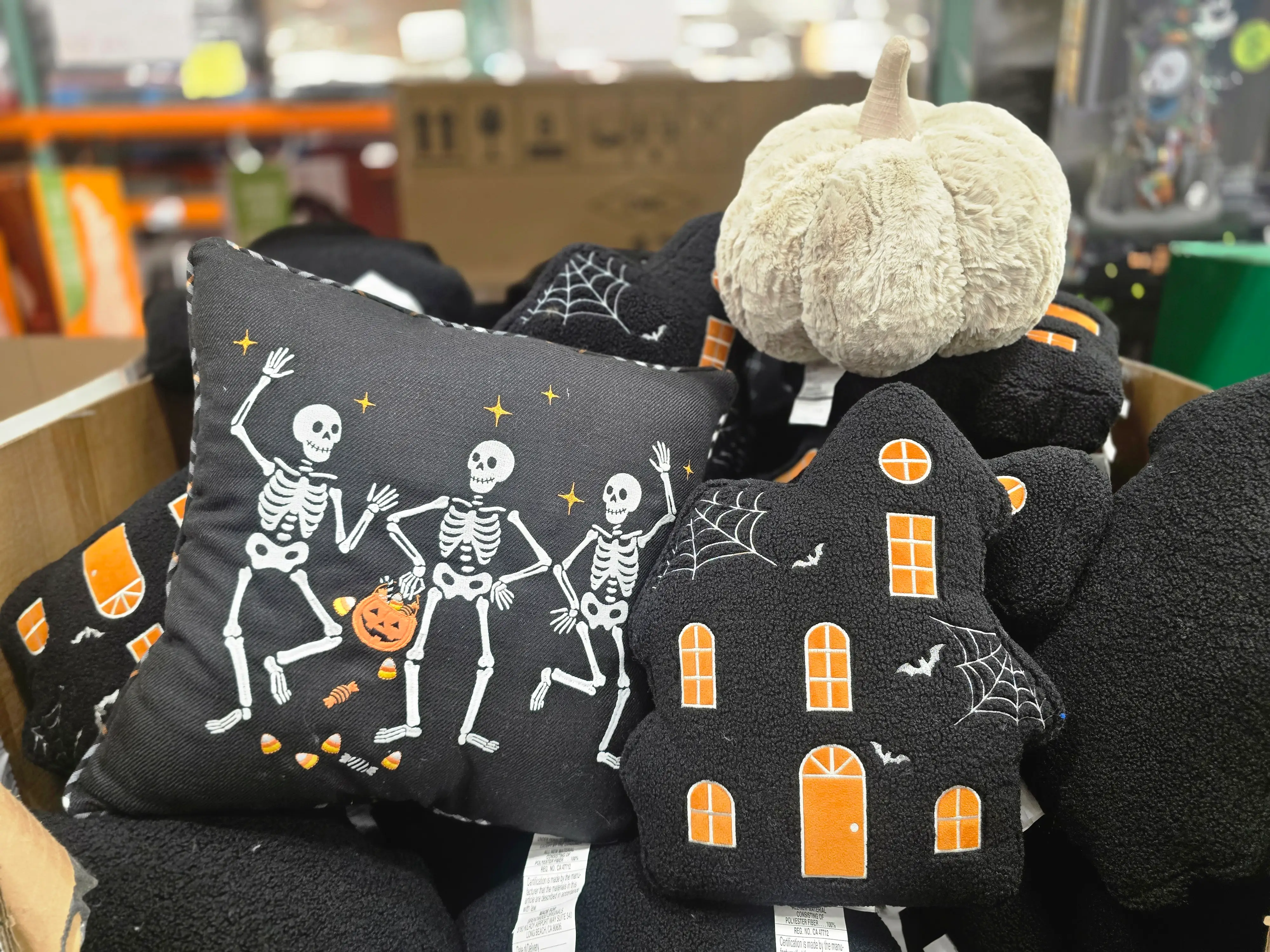 Various Halloween throw pillows on display at Costco.