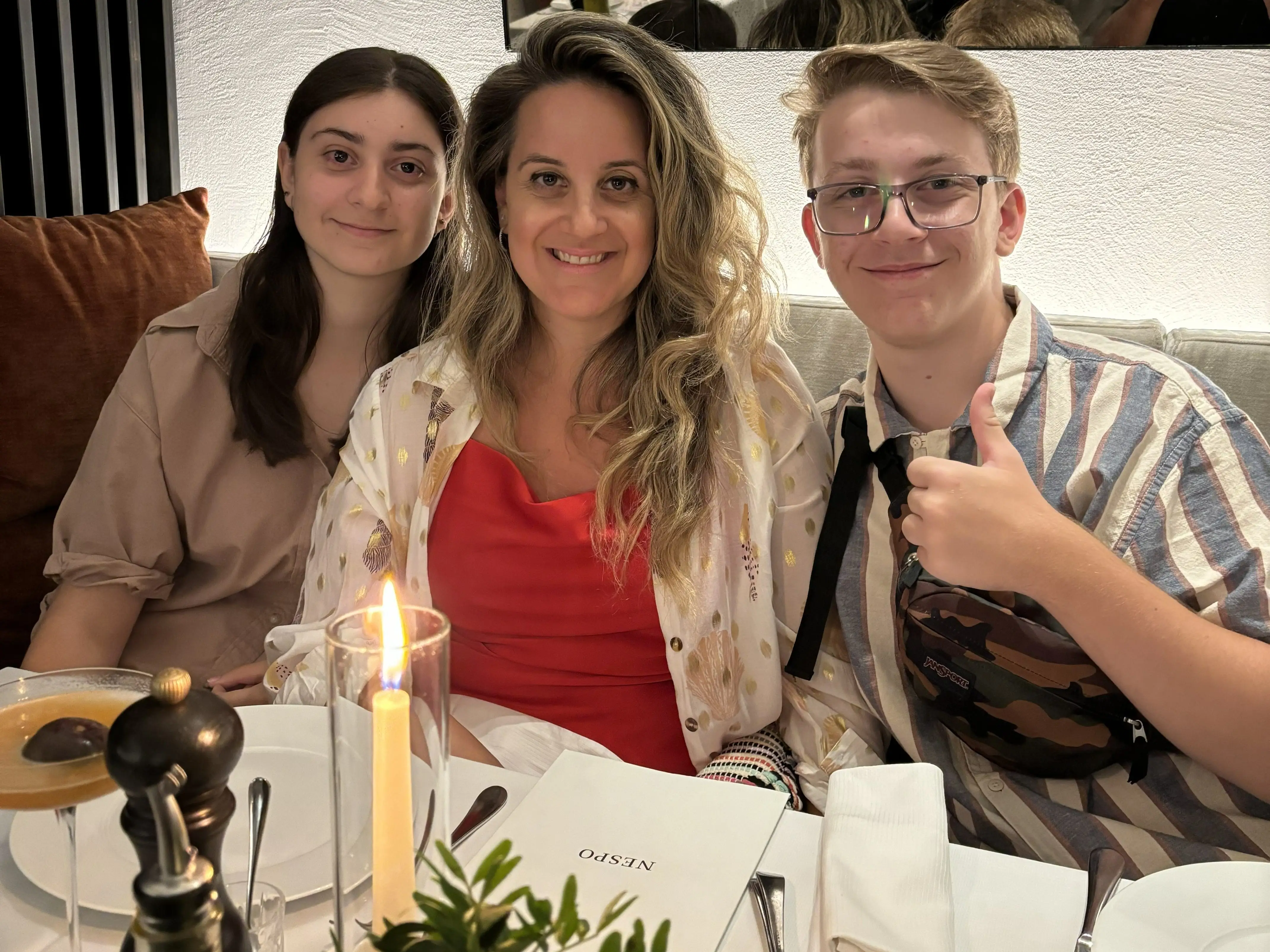 The author (center) sits at a restaurant table with her two children.