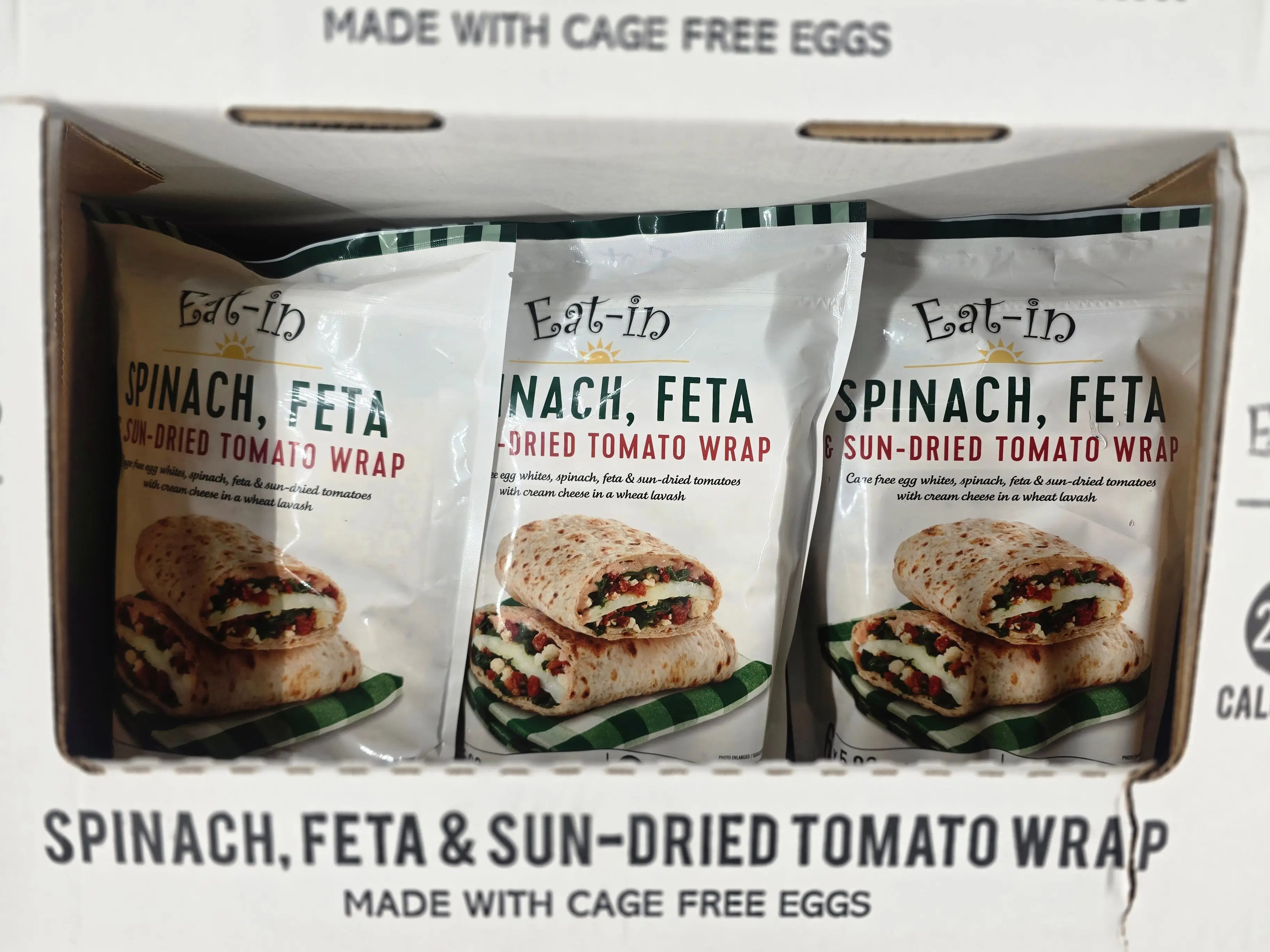 Bags of Eat-in spinach, feta, and sundried tomato wraps on display at Costco.