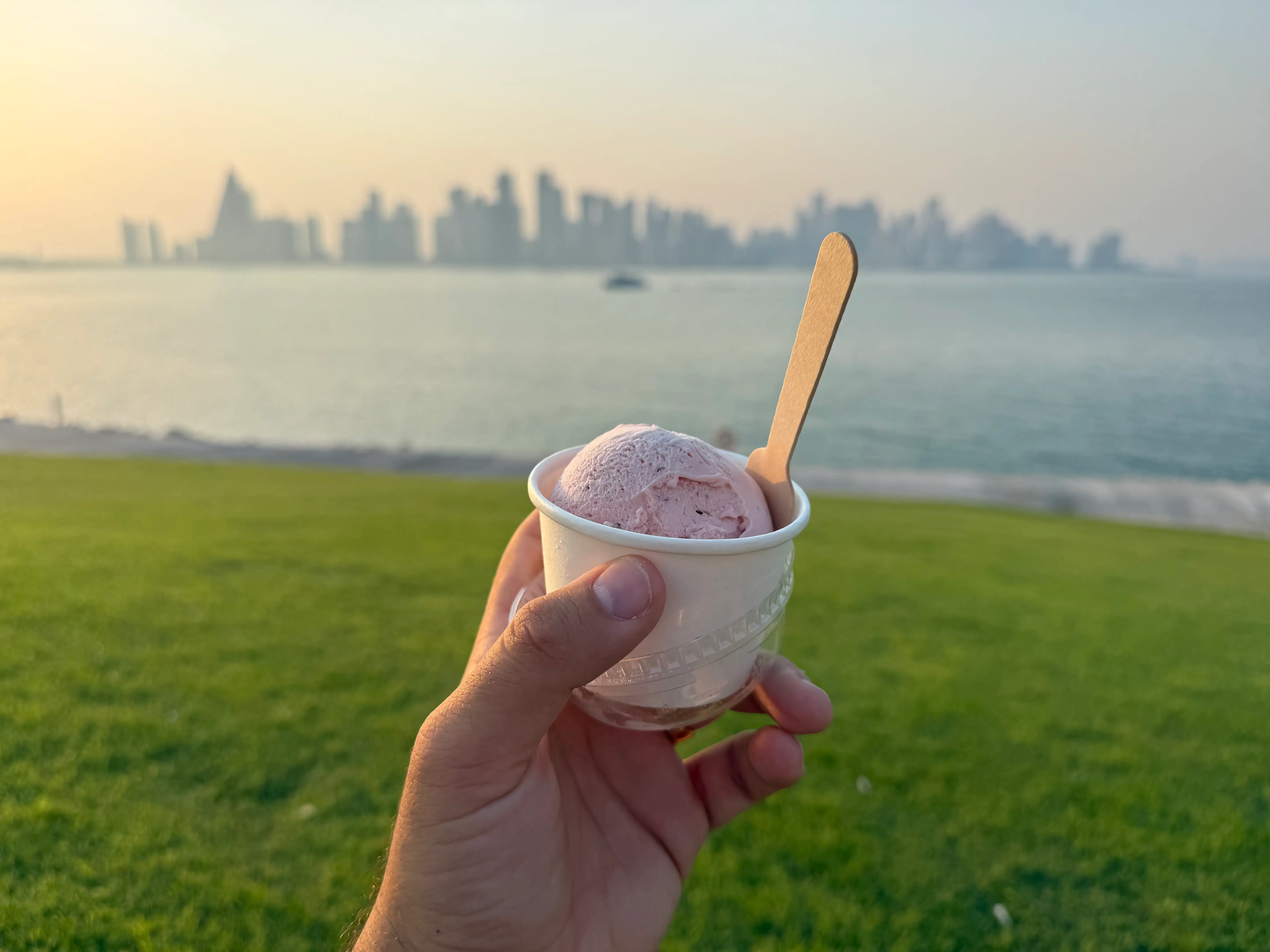 The author holding pink ice cream in Doha.