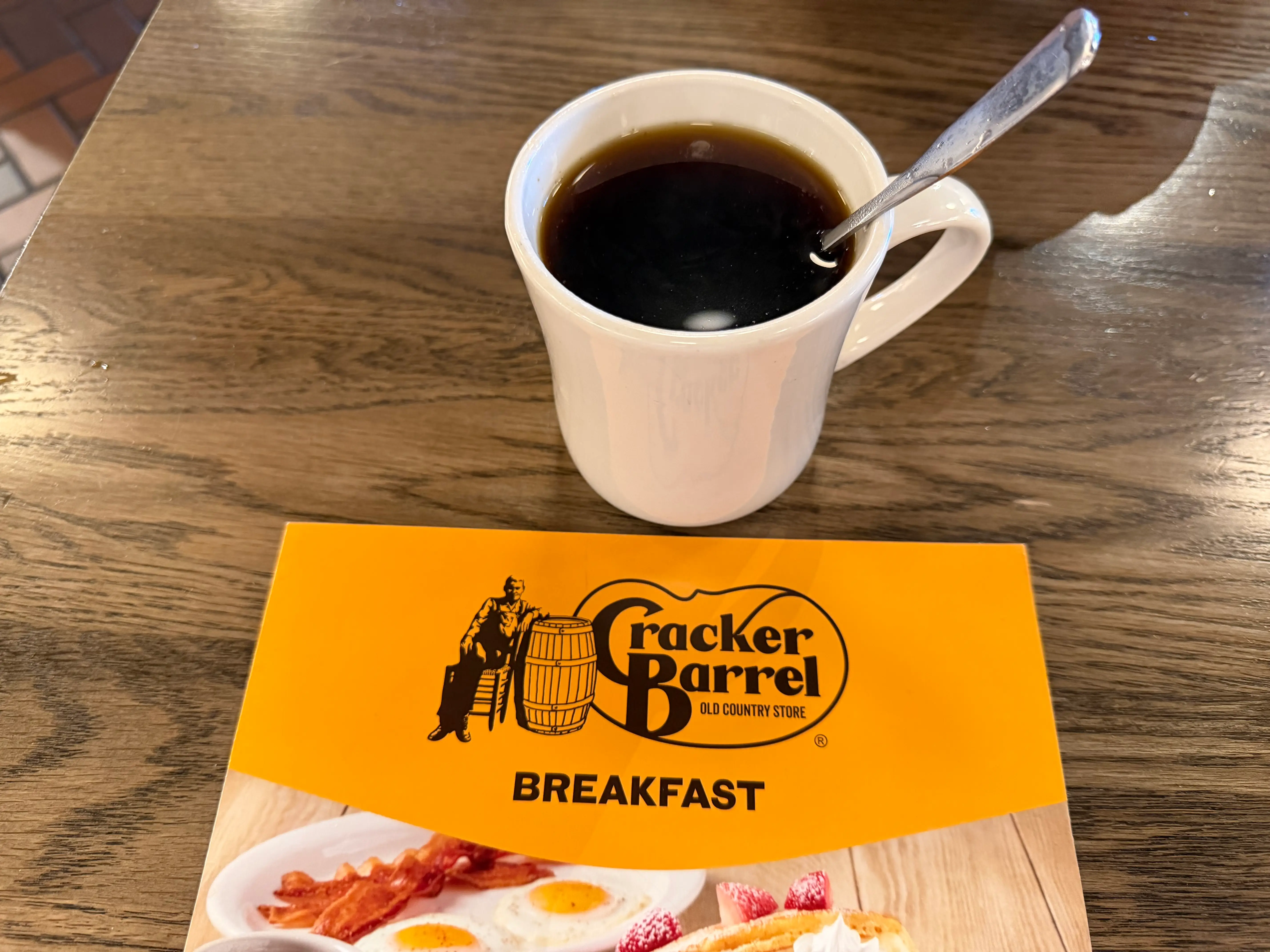 mug of coffee at cracker barrel next to cracker barrel menu