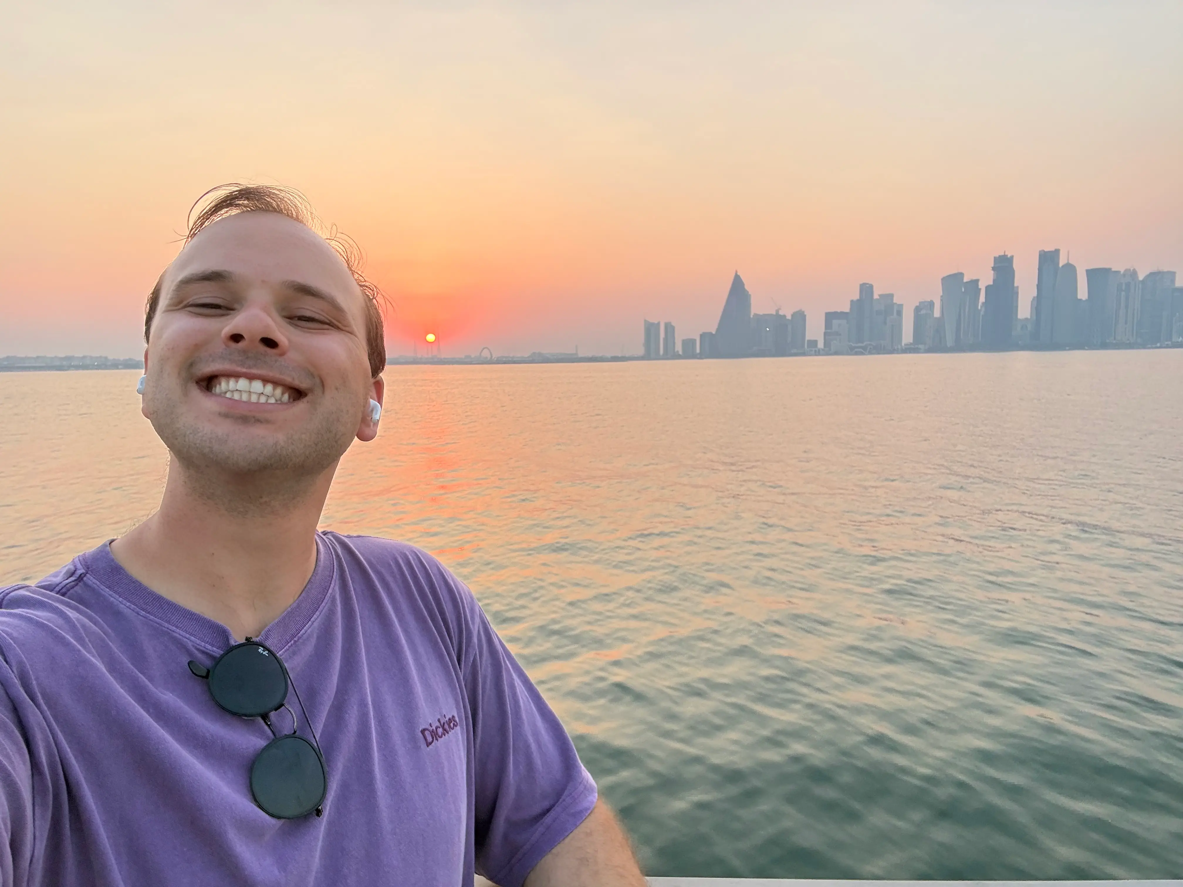 The author in a purple shirt in Doha.