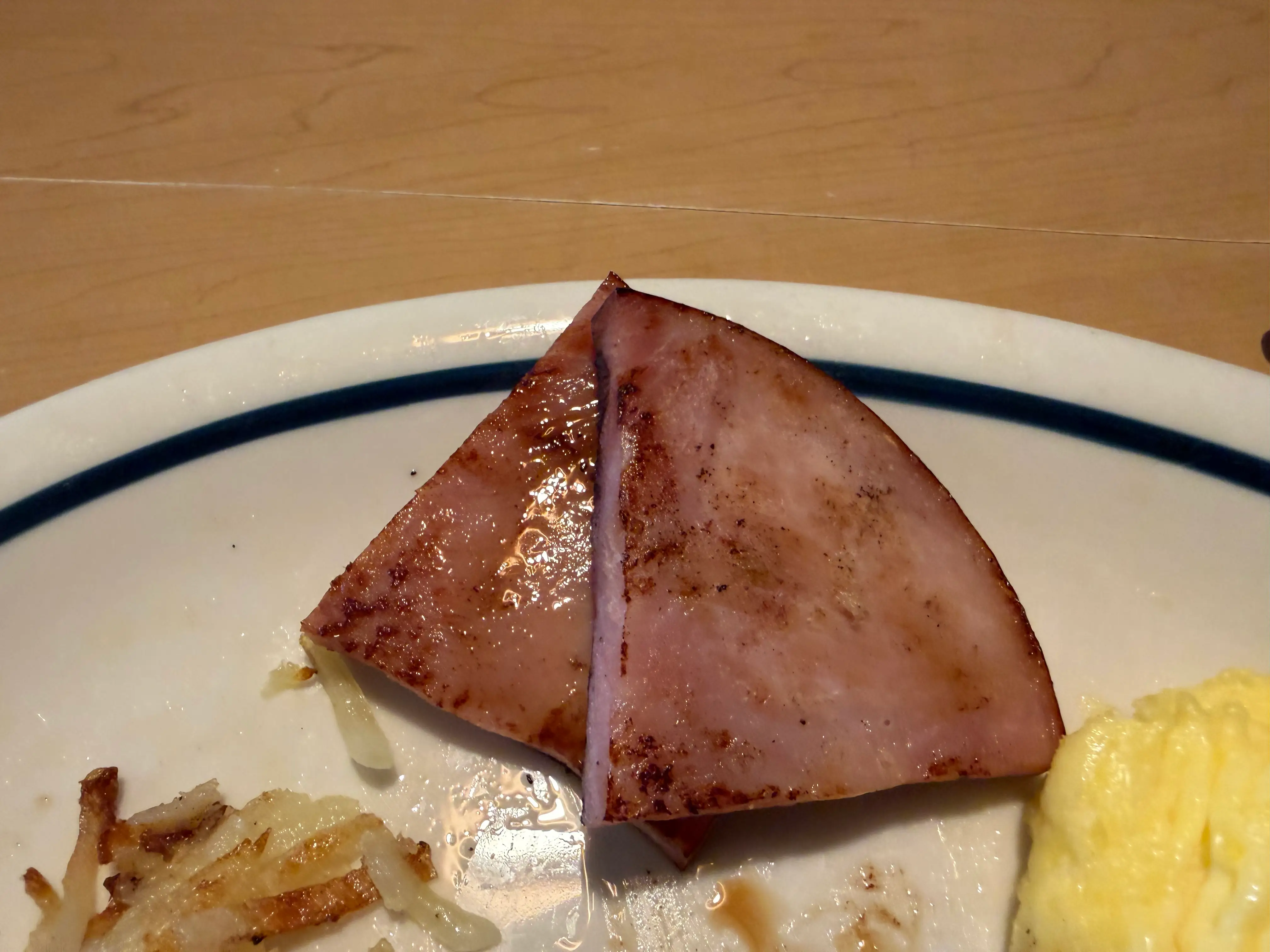 Two quarter slices of ham on plate at IHOP